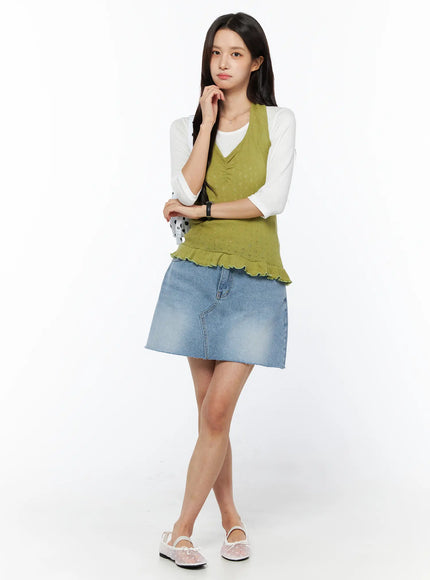 Frill Hem Halter Neck Top CU522 in green, full-body front view on model, relaxed pose, pointelle knit sleeveless top with frill hem, styled over white tee and blue denim mini skirt with floral flats.