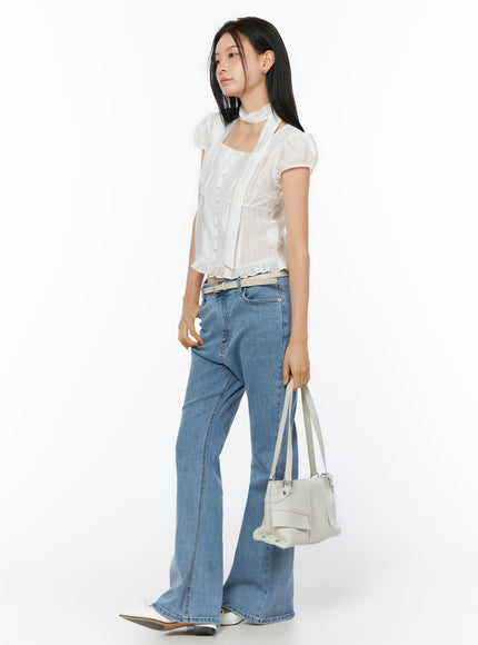 Puff Sleeve Shirred Blouse with Scarf IU519 in white, full-body side profile on model, puff sleeves and ruffled hem visible, paired with flare jeans, belt, and white shoulder bag.