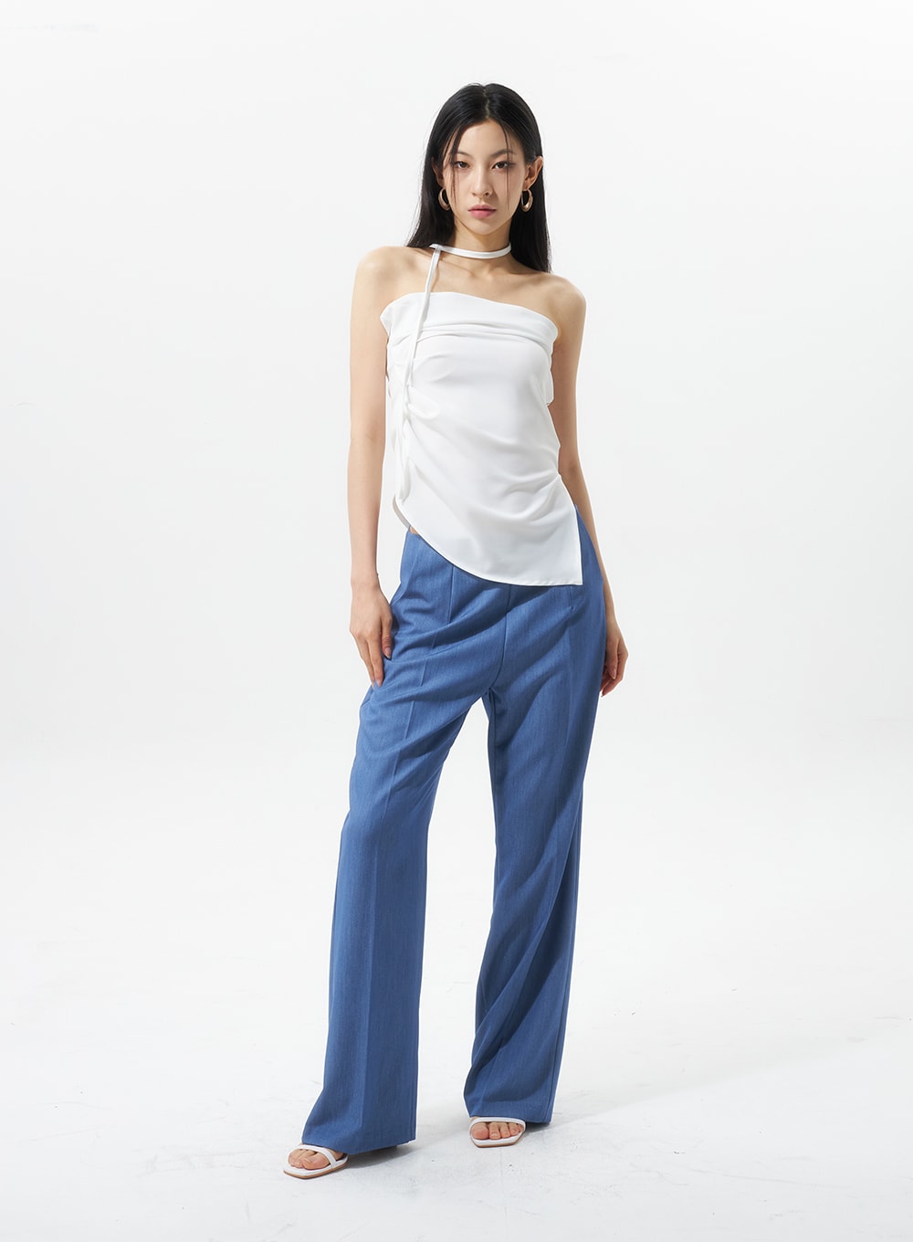 Low Rise Tailored Pants IU326 in blue, full-body front view on model standing straight, low-rise waistband and pressed center crease visible, styled with white halter top.