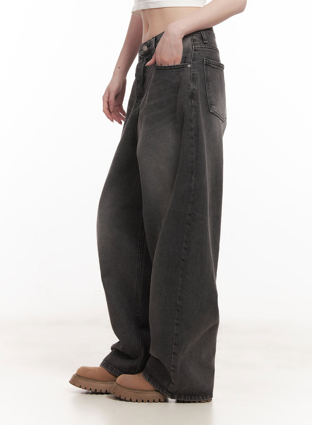 Dianna Baggy Jeans CM518 in dark gray, side view on model hand in pocket, showing extreme wide-leg silhouette and washed fading, paired with brown chunky loafers.