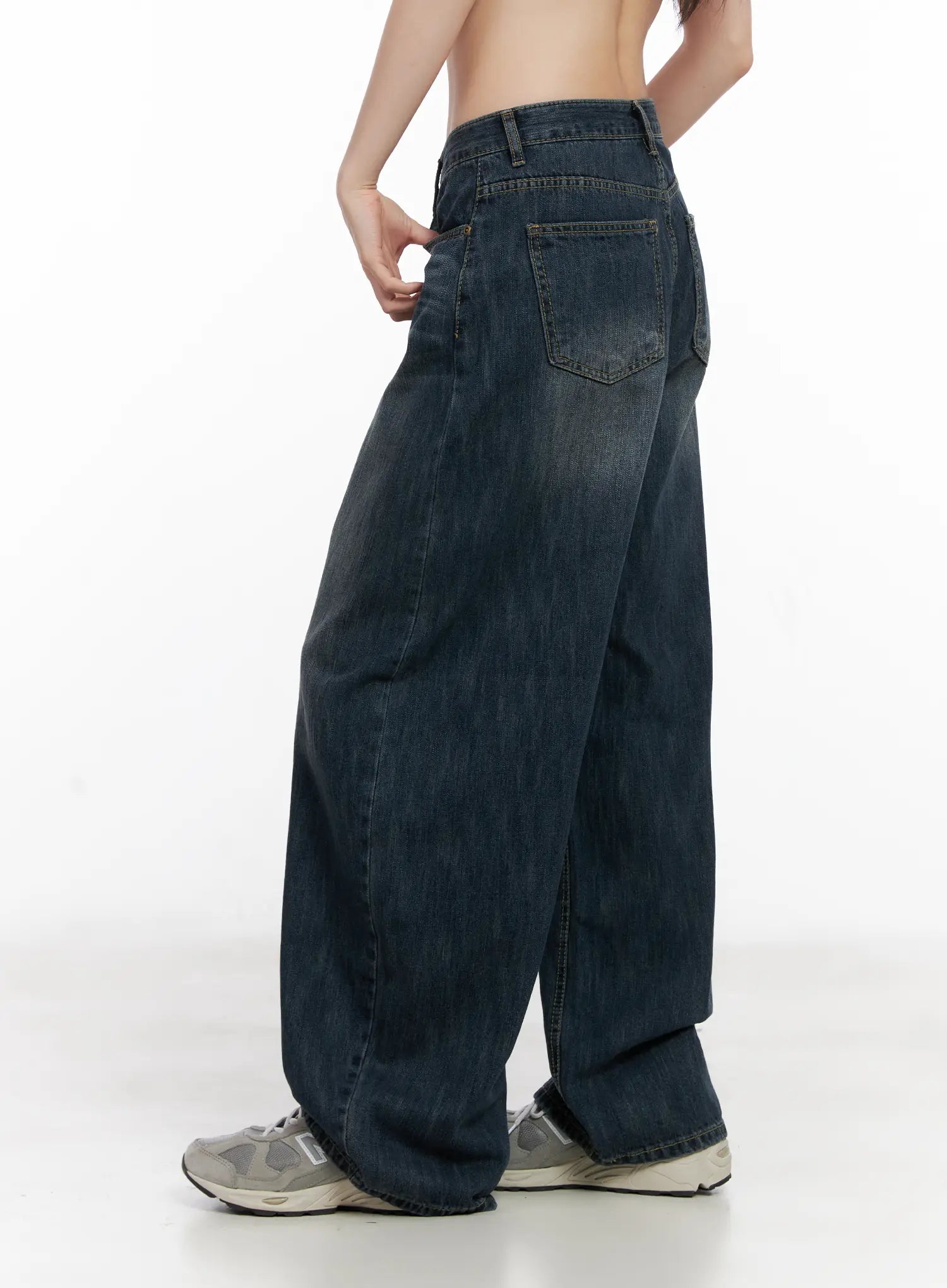 Seoy Washed Denim Jeans CG525 in dark blue, side-back view on model, showing back pocket detail and wide barrel leg silhouette with washed cotton denim.