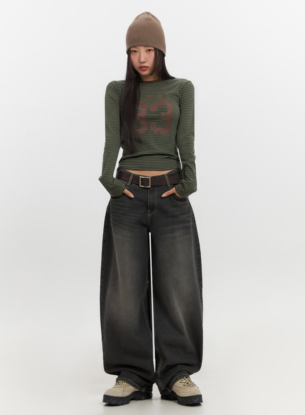 Skyla Washed Wide-Leg Baggy Jeans IF511 in washed black, front full-body shot on model, hands in pockets, oversized baggy denim with faded wash, styled with green striped top and beanie.