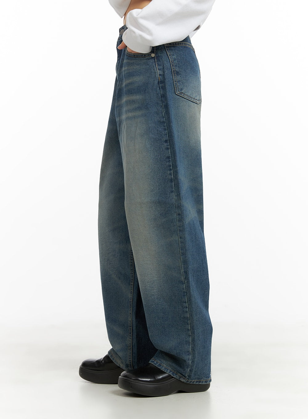 Washed Wide Leg Jeans CA419 in blue, side view on model, wide-leg cotton denim with vintage wash and subtle fading, floor-grazing length, paired with white top and black loafers.