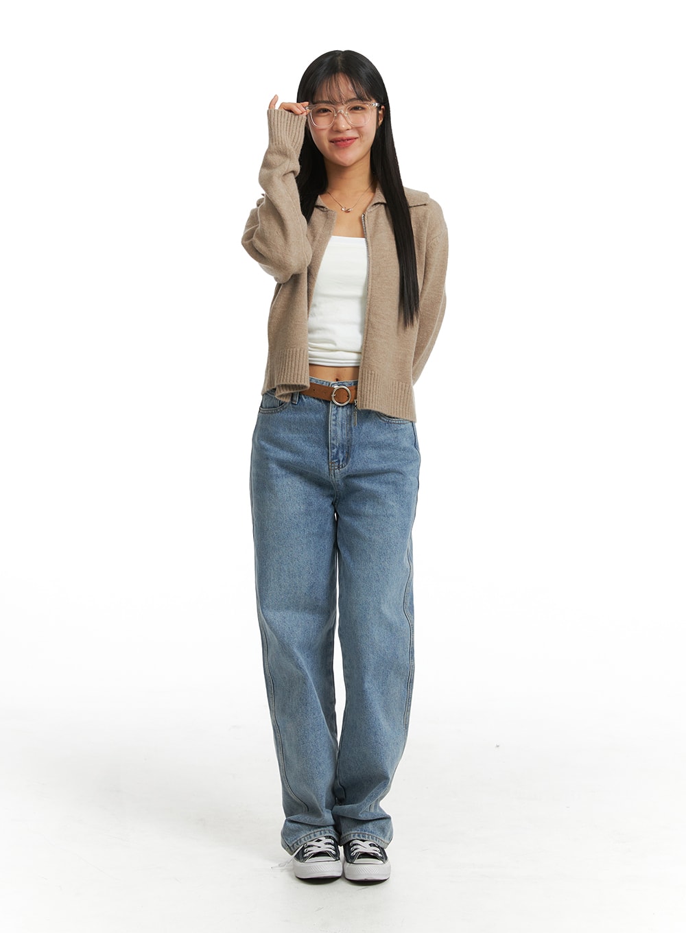 Washed Straight Wide Denim OJ405 in blue, full-body front on model adjusting glasses, straight wide leg, brown belt, styled with beige knit cardigan and white tube top.