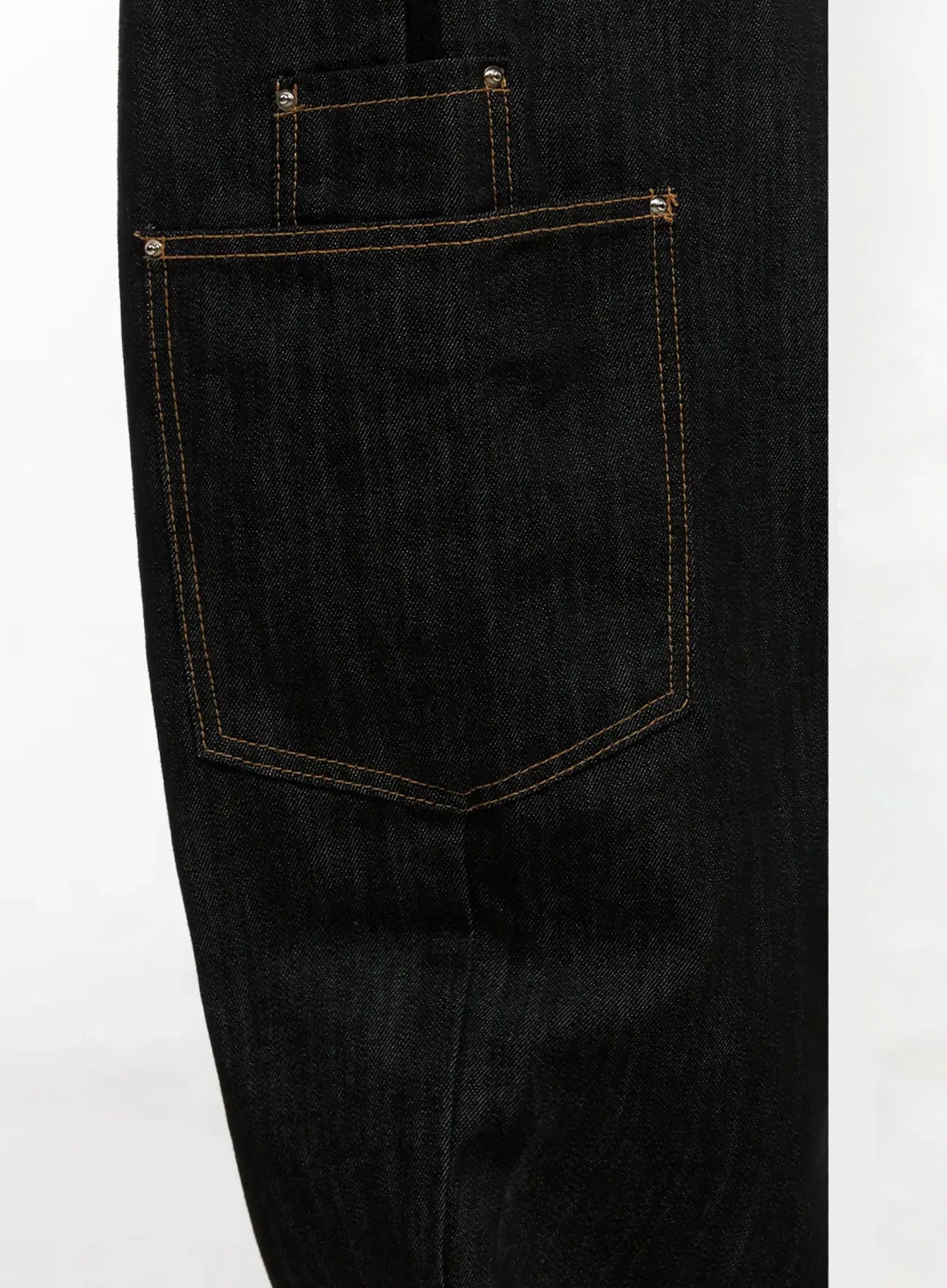 Dahee Wide-Leg Cargo Jeans IG508 in black, flat detail close-up of back pocket, showing contrast gold topstitching, rivet hardware, and raw denim texture.