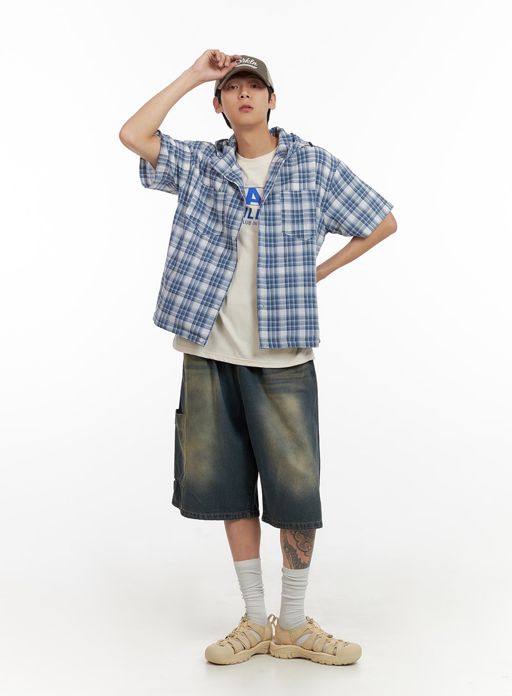 Men's Denim Washed Shorts (Blue) IL404 in blue, front full-body on model, relaxed wide-leg silhouette with vintage wash, paired with plaid overshirt and cap.