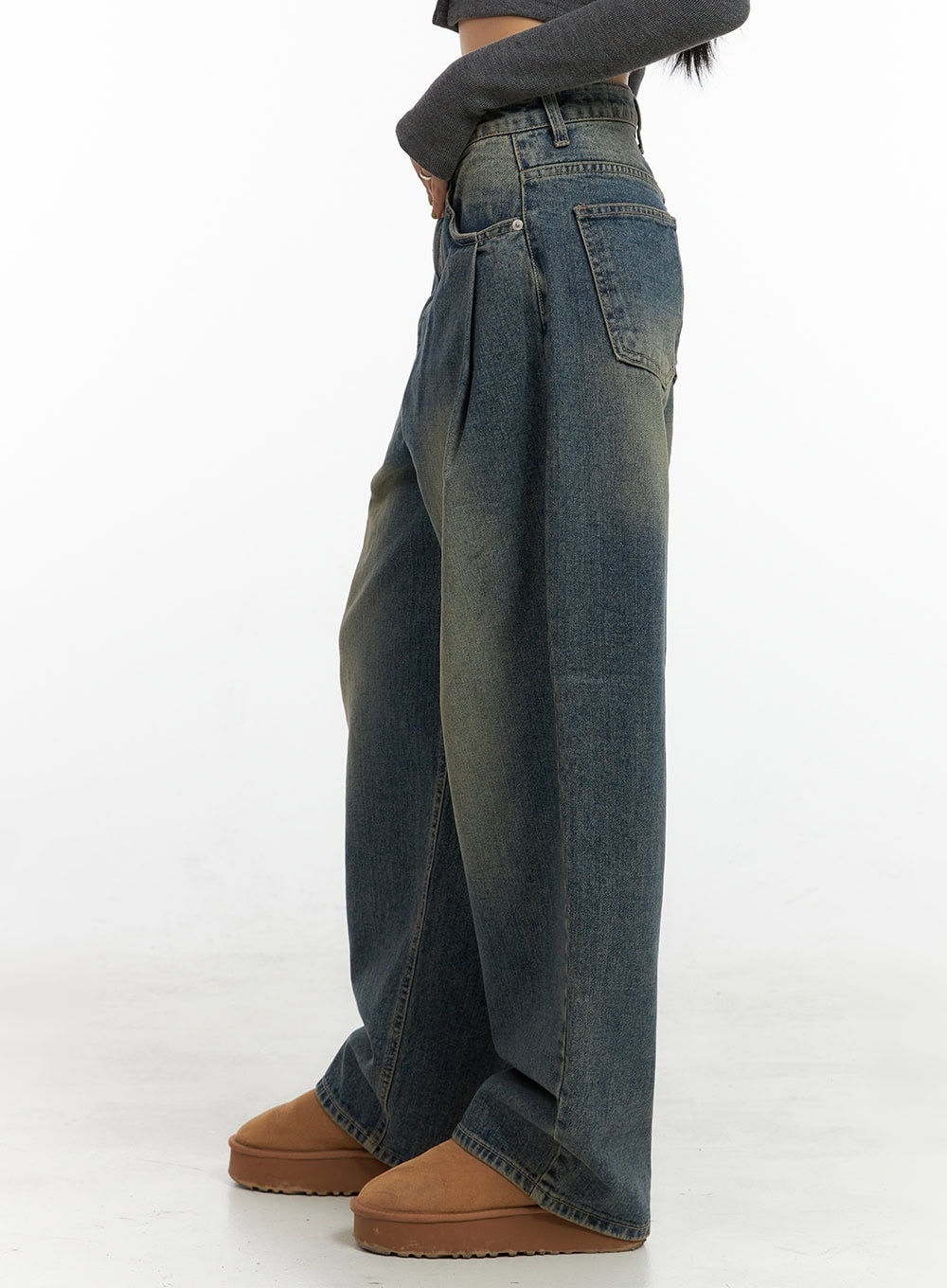 Peyton Pin-Tuck Washed Baggy Jeans CO424 in blue, side close-up on model, pintuck pleat detail and back pocket visible, relaxed wide-leg cotton denim with yellow washed fading.