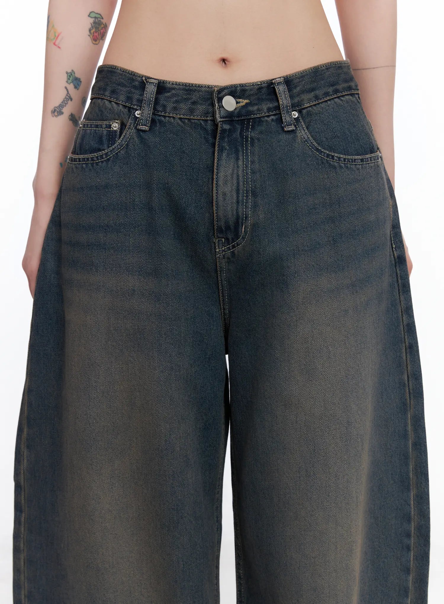 Ocean Faded Balloon Fit Jeans CS510 in washed dark indigo, waist close-up on model, front pockets and button fly detail visible, faded sun-bleached wash across thighs.