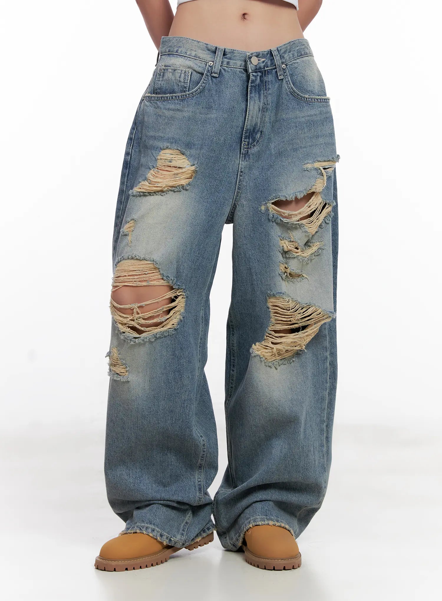 Manon Washed Distressed Wide Jeans CL518 in blue, front mid-shot on model, waistband and five-pocket detail visible, multiple large destroyed holes with frayed edges across knees and thighs.