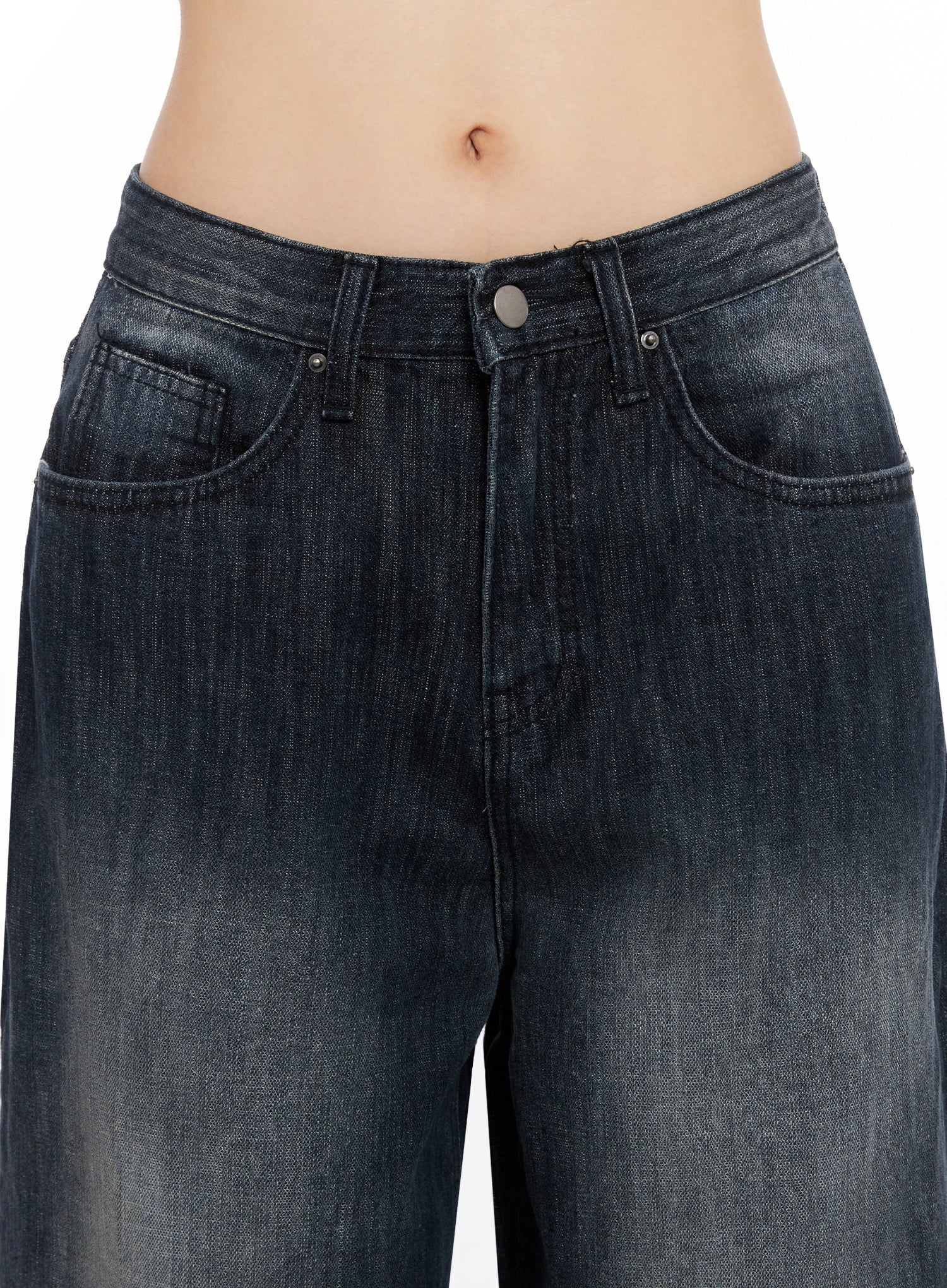 Minnell Vintage-Wash Wide-Leg Jeans IO517 in dark blue, close-up waistband and front pocket detail, showing button fly, coin pocket, and vintage-wash denim texture on model.