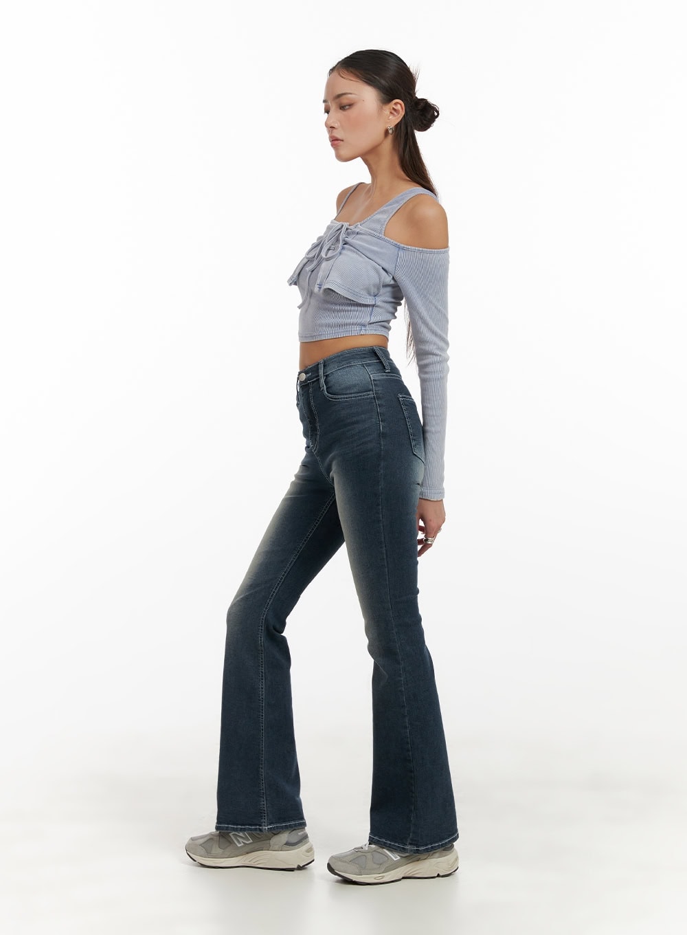 Washed Denim Slim Fit Bootcut Jeans CY402 in blue, full-length side profile on model, showcasing slim silhouette and bootcut flare from knee, washed denim, paired with crop top and sneakers.