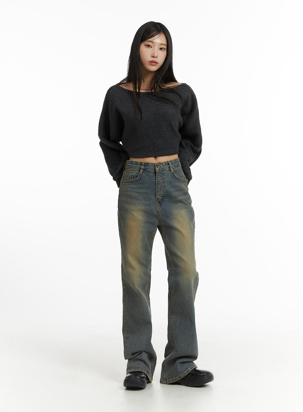 Washed Slim Fit Bootcut Jeans CJ431 in blue, full-length front on model with hands in pockets, worn with off-shoulder grey crop knit, visible golden fading wash on thighs and bootcut flare at hem.