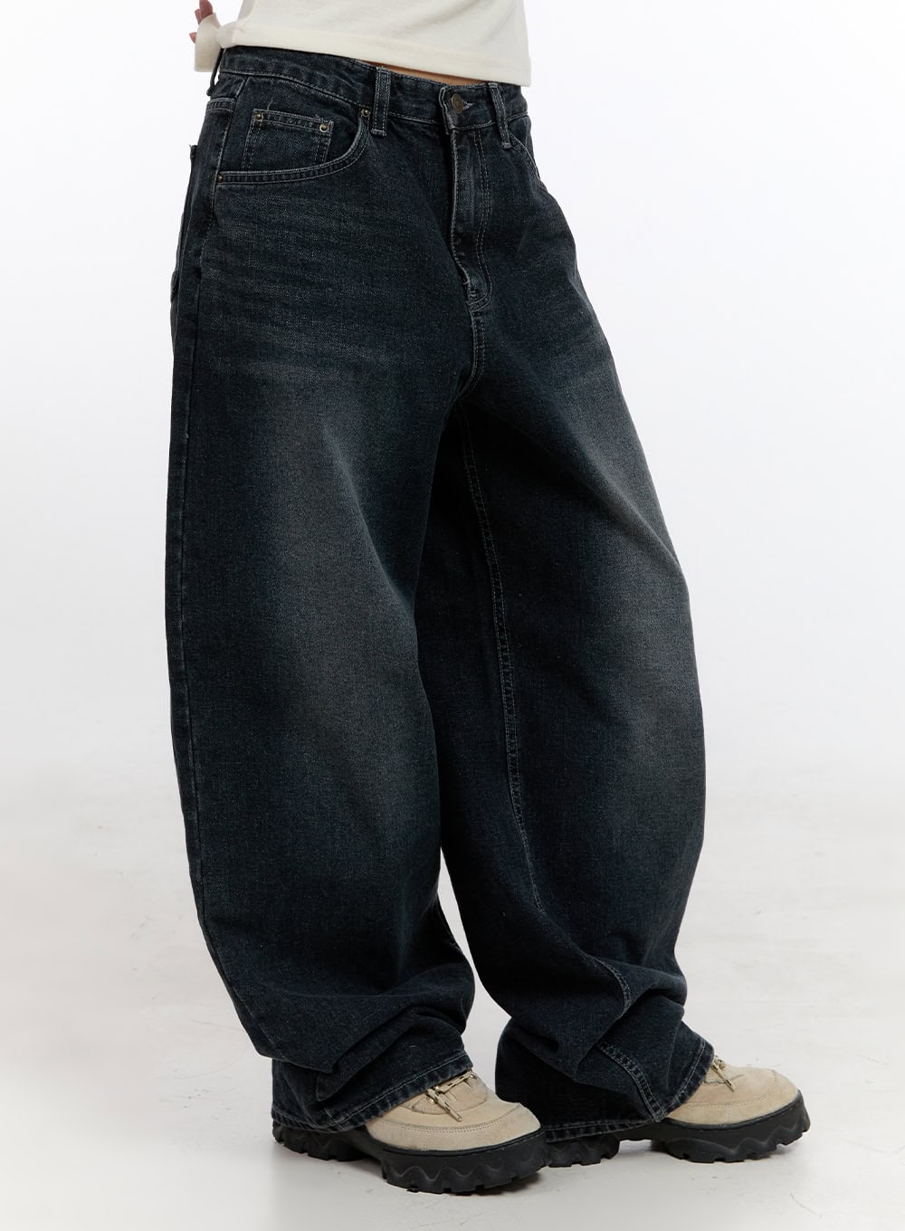 Camila Washed Cotton Jeans CN422 in dark blue, side close-up on model, exaggerated wide baggy leg with washed cotton denim, visible side seam and deep crotch drop, chunky sneakers.