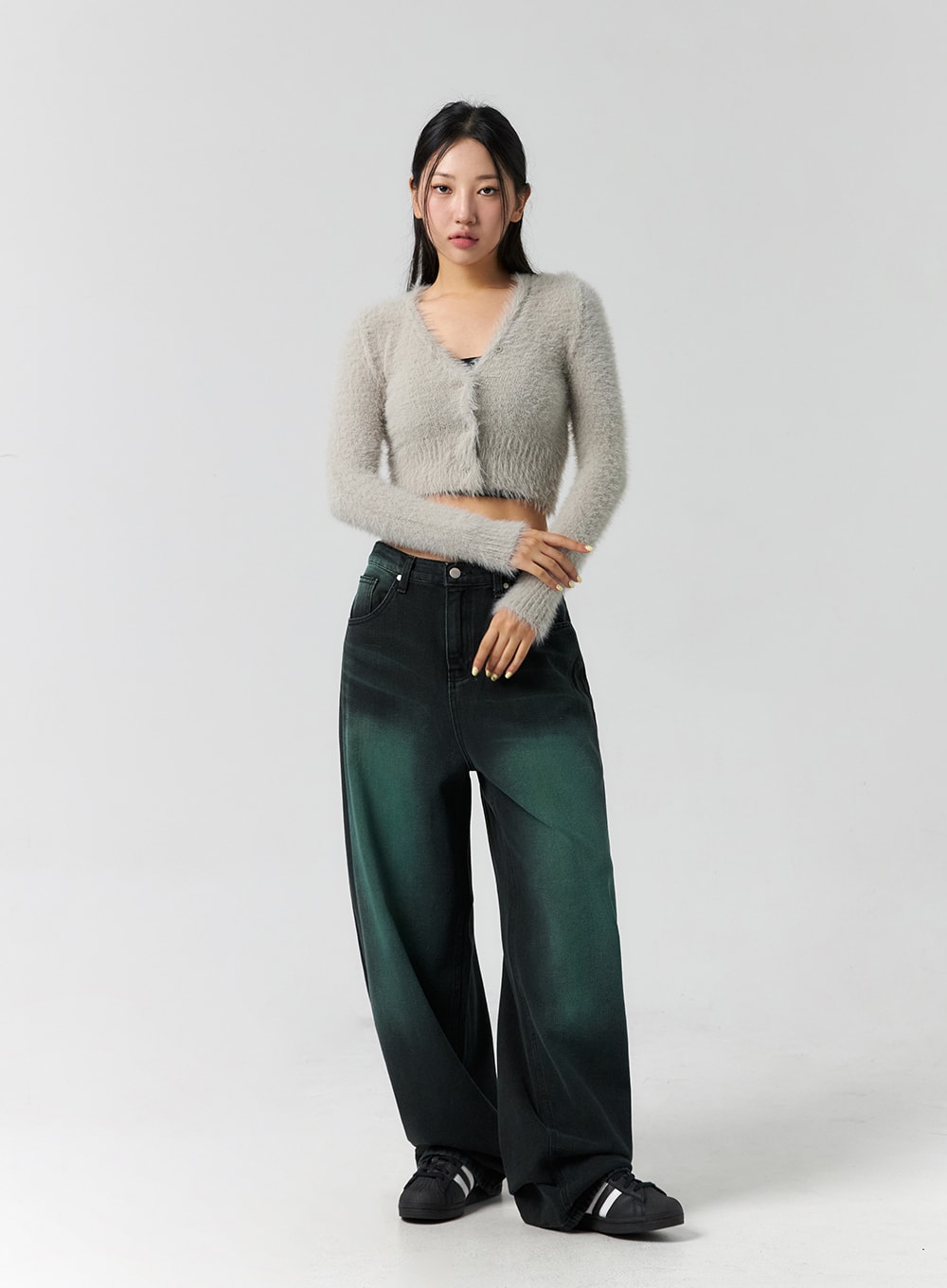 Comfy Wide Leg Color Jeans CS305 in dark green, full-length front shot on model with hands clasped, relaxed wide-fit denim, worn with grey fuzzy crop cardigan and black sneakers.
