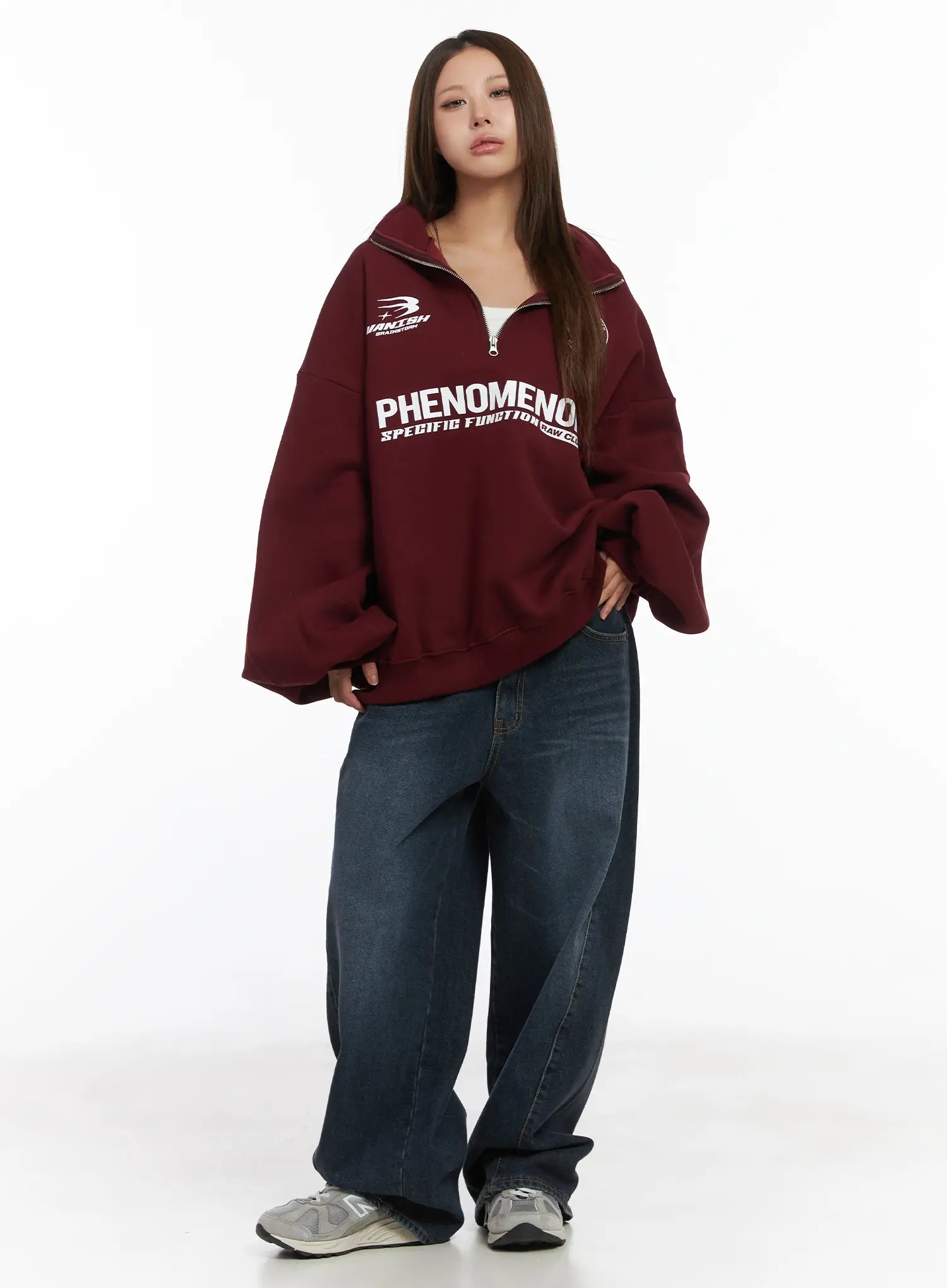 Everly Wide Leg Jeans CJ513 in dark blue, full-body front view on model, relaxed wide fit washed cotton denim, paired with oversized burgundy graphic half-zip sweatshirt and grey sneakers.