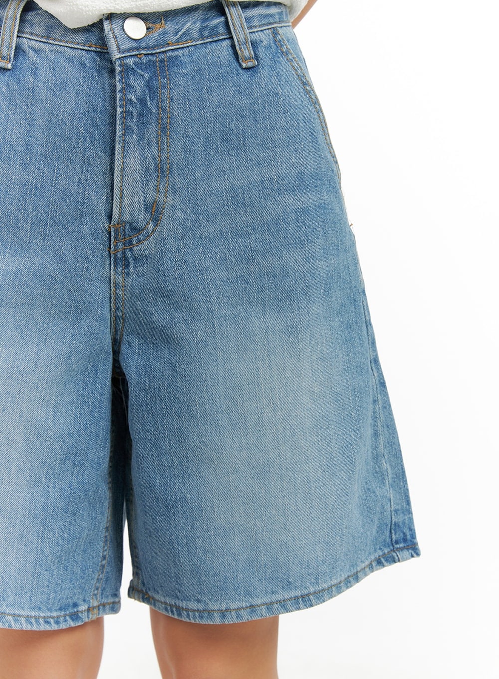Washed Wide Leg Jorts CA409 in blue, close-up front detail on model, washed denim texture, gold contrast stitching, slash pocket, and silver button waistband.