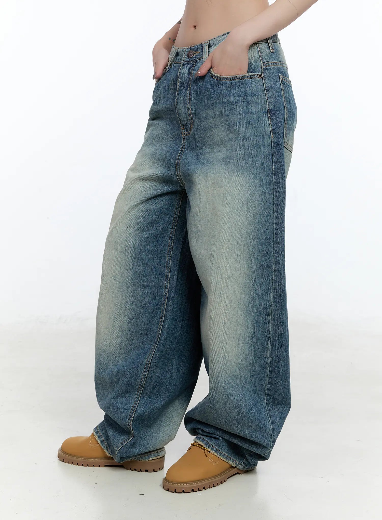 Jiso Baggy Wide Jeans CN517 in blue, side view on model with hand in front pocket, washed cotton wide leg silhouette showing exaggerated balloon shape and long inseam.