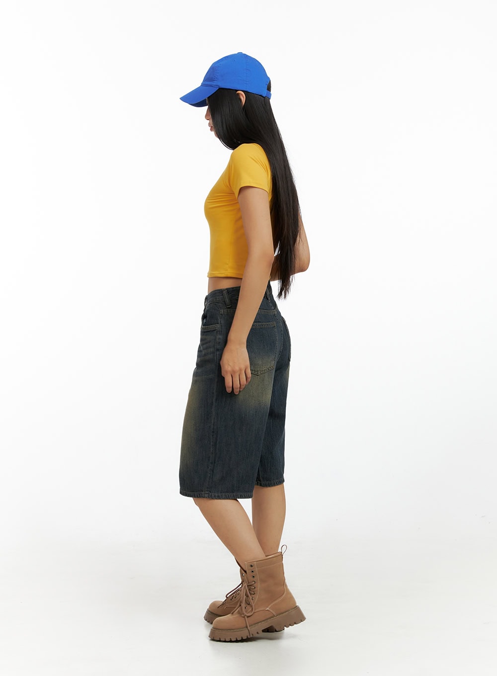 Dark Washed Wide Leg Jorts IL419 in dark blue, side view on model showing relaxed straight silhouette and knee length, styled with yellow crop tee and lace-up combat boots.