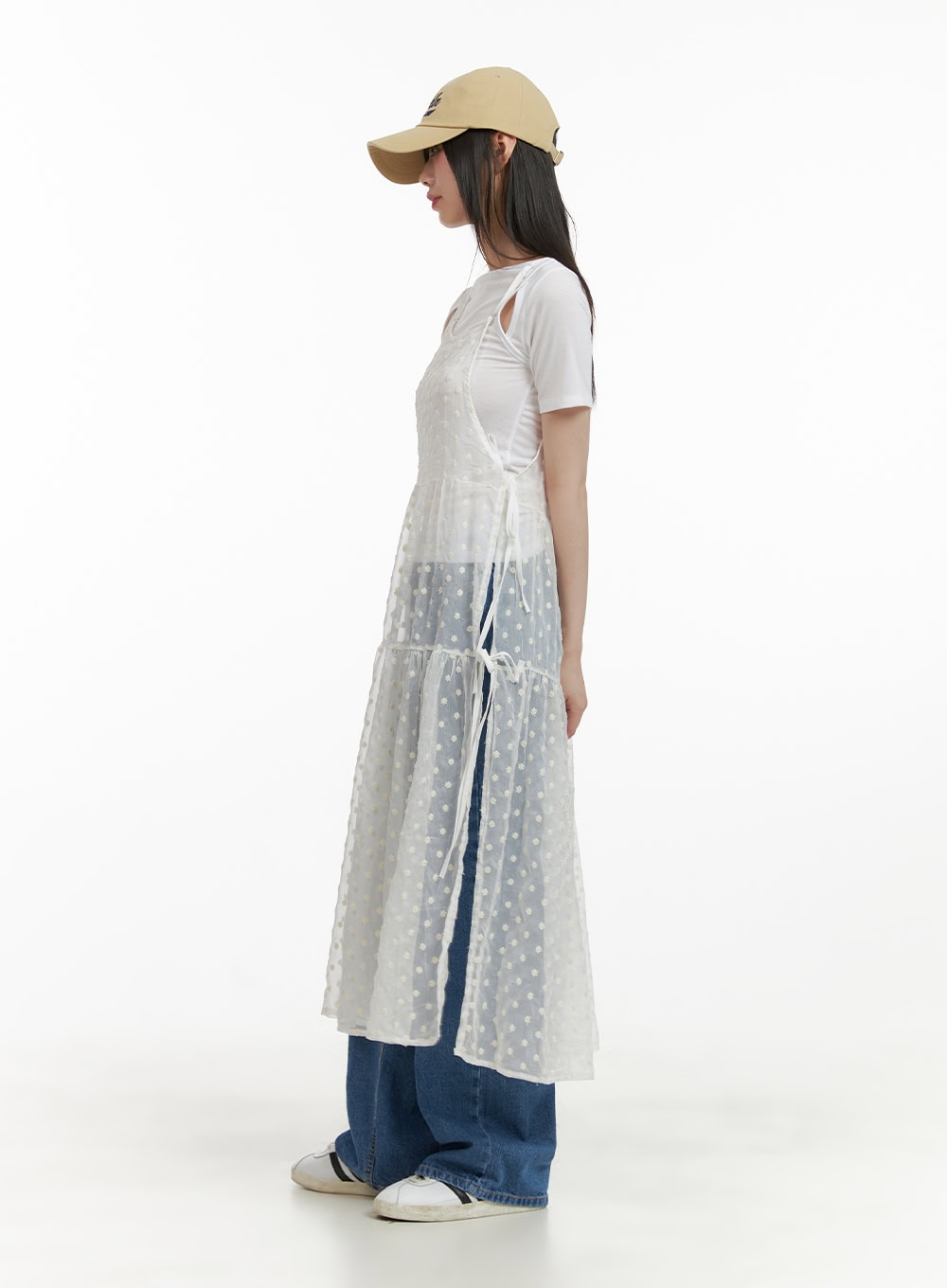 Blue Straight Leg Jeans CY428 in blue, full-body side shot on model, wide-fit washed denim styled under sheer tiered polka-dot dress and white tee, cap and sneakers.