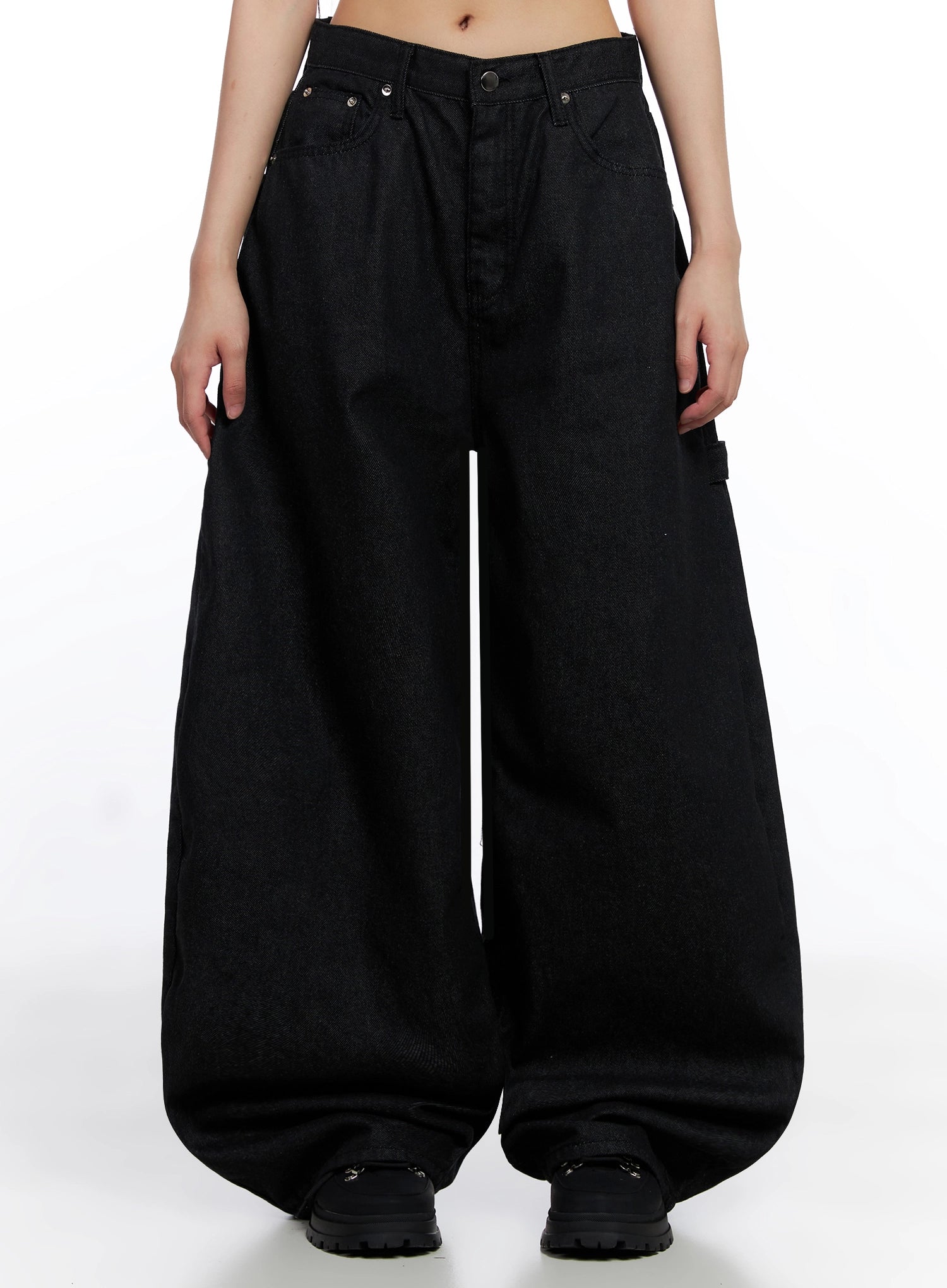 Lea Cross-Patch Baggy Jeans IS525 in black, front full-length product shot on model, extreme wide-leg loose fit cotton denim with silver rivet studs at waistband, pooling hem, paired with chunky black boots.