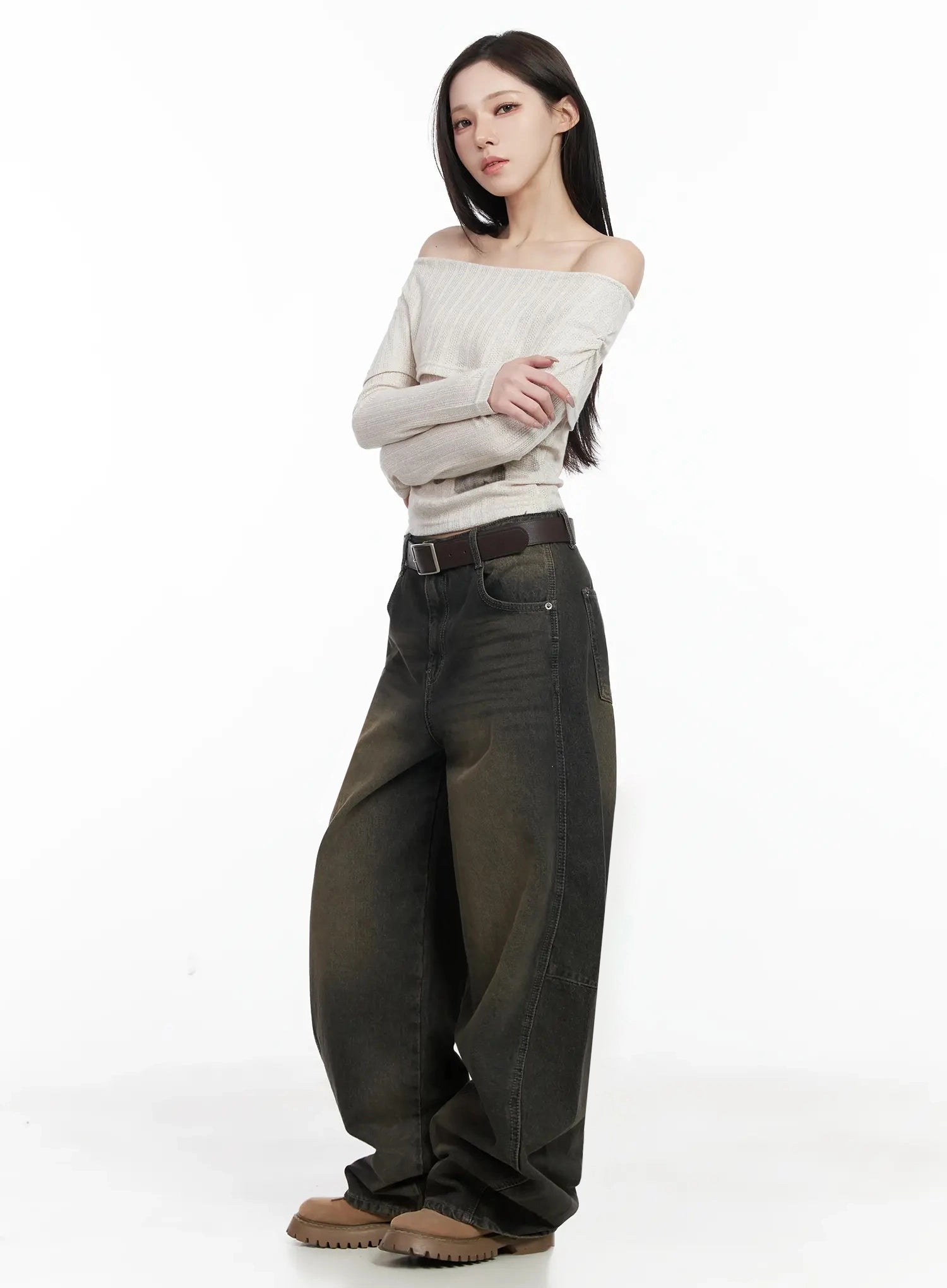 Tracey Vintage Black Washed Wide Leg Jeans IJ528 in black, side full-body shot on model, wide-fit cotton denim with brown vintage wash, paired with off-shoulder knit top, brown belt, chunky boots.