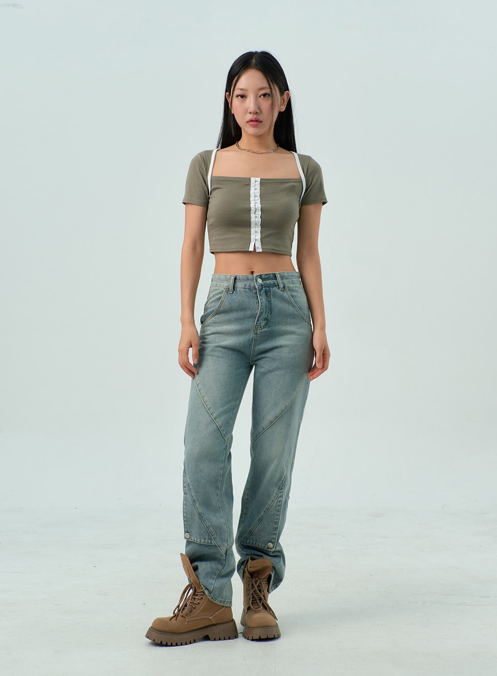 Straight Leg Jeans CY330 in light blue wash, full-length front standing shot on model, straight-fit washed denim with curved seam panels, styled with olive crop top and tan lug-sole boots.