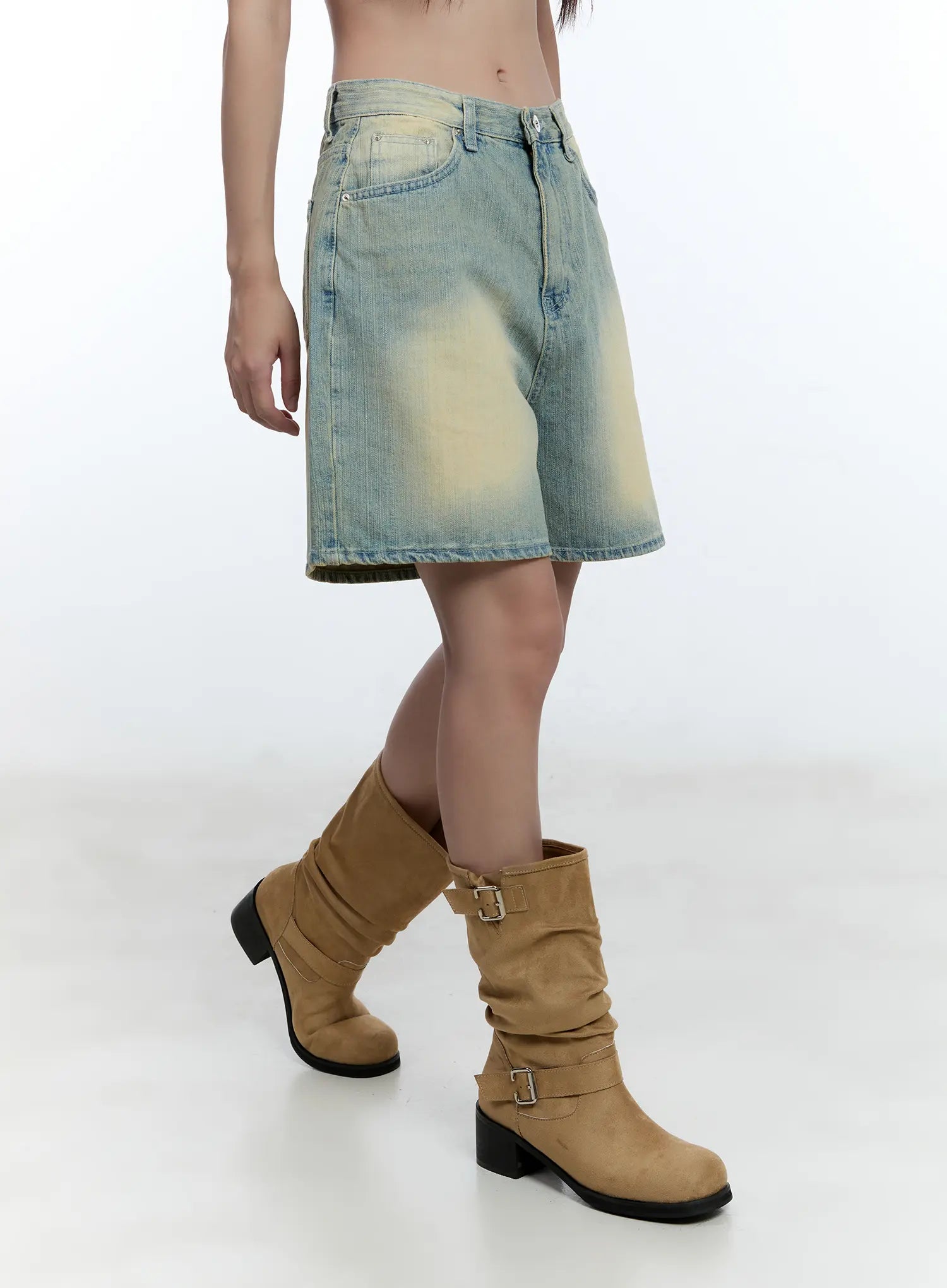 Vintage Wash Jorts CU527 in light blue, side view on model, wide-leg half-length denim with faded yellow vintage wash, styled with tan buckle boots.
