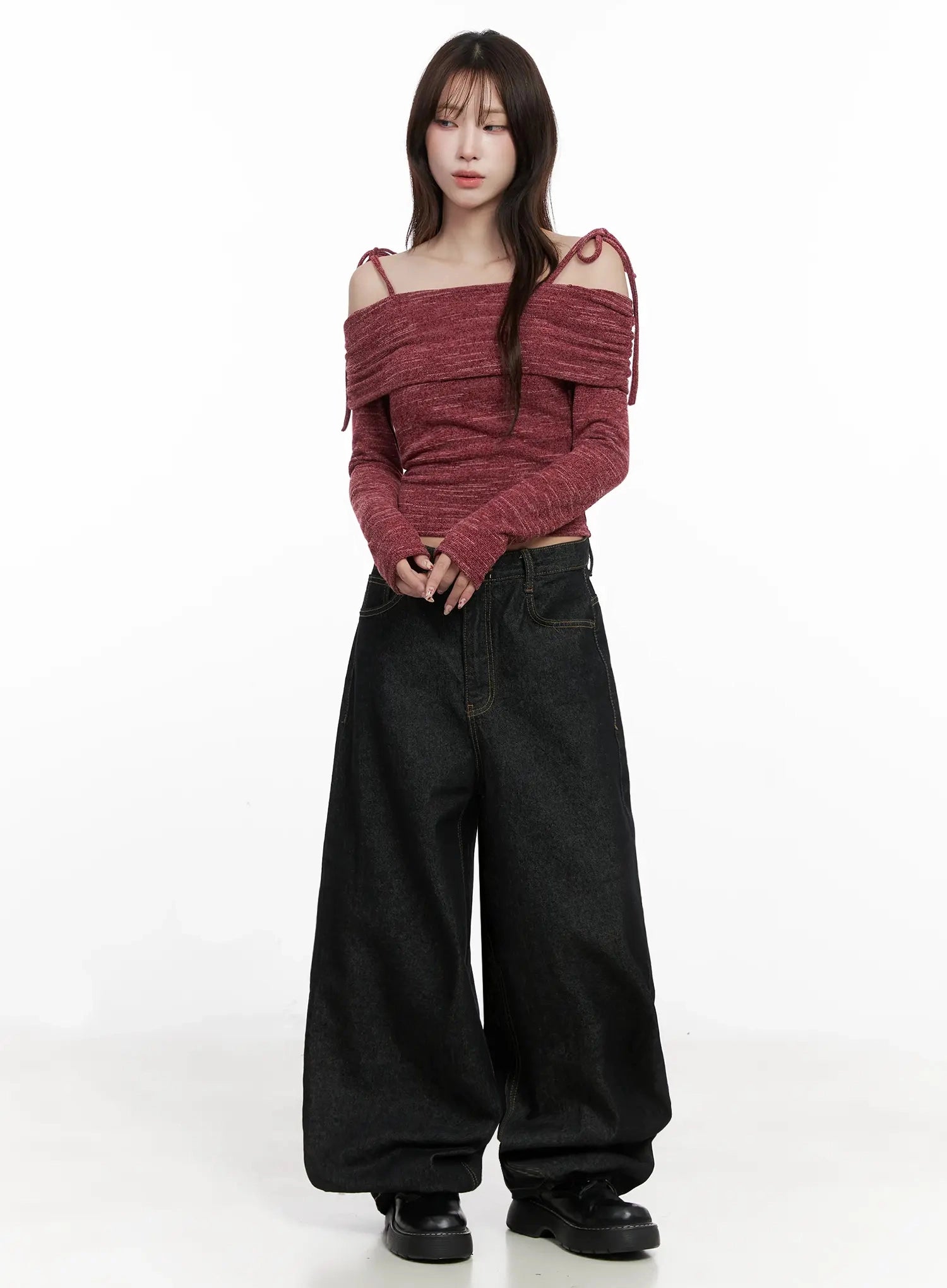 Halo Wide Leg Stitch Detail Jeans IN514 in black, full-body front on model with hands clasped, voluminous wide-leg silhouette with gold topstitch, paired with red off-shoulder long-sleeve top.