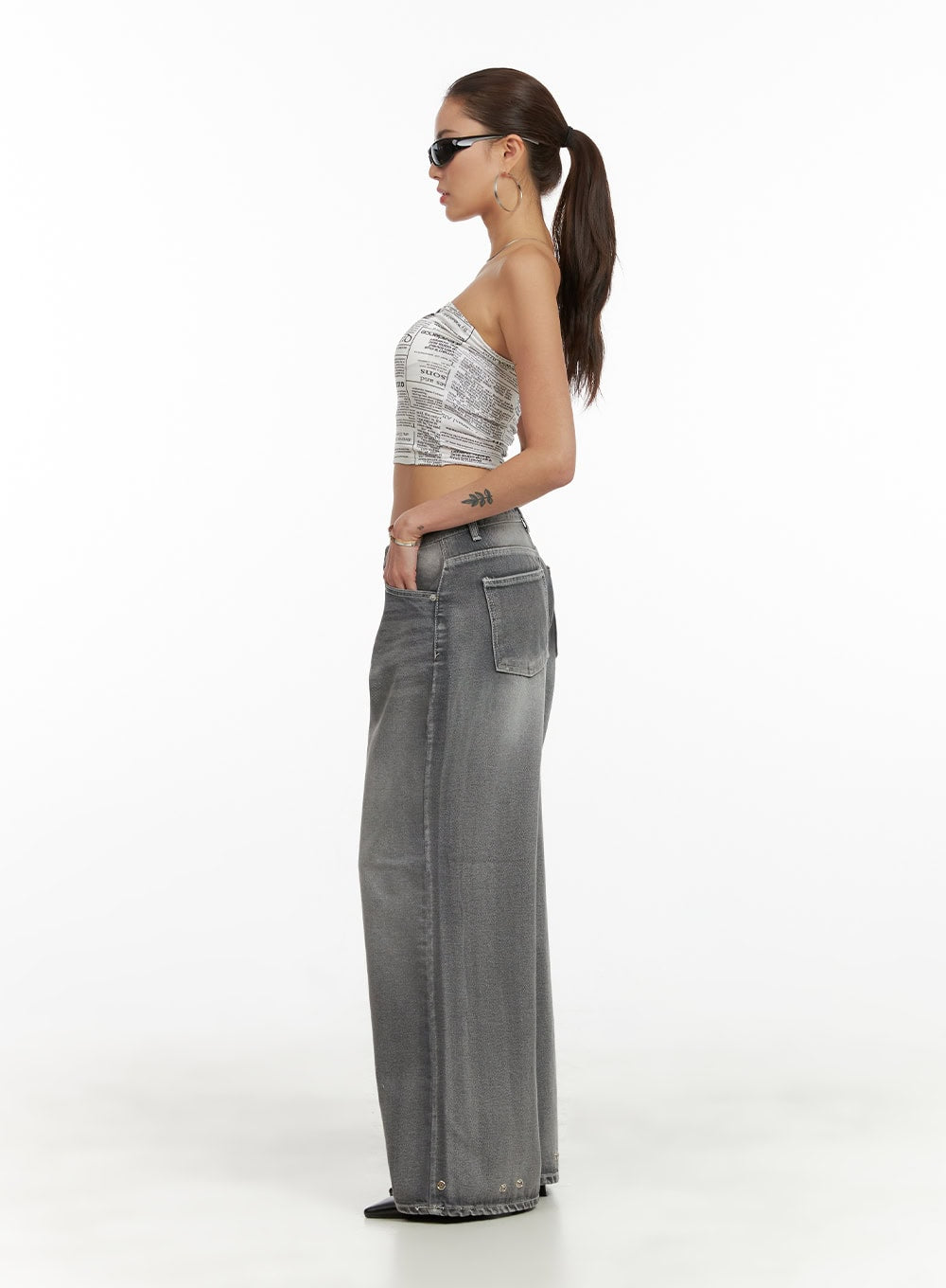 Low Rise Baggy Jeans CY431 in gray, side view on model showing patch pocket detail, low-rise wide leg washed denim with eyelet hem hardware.
