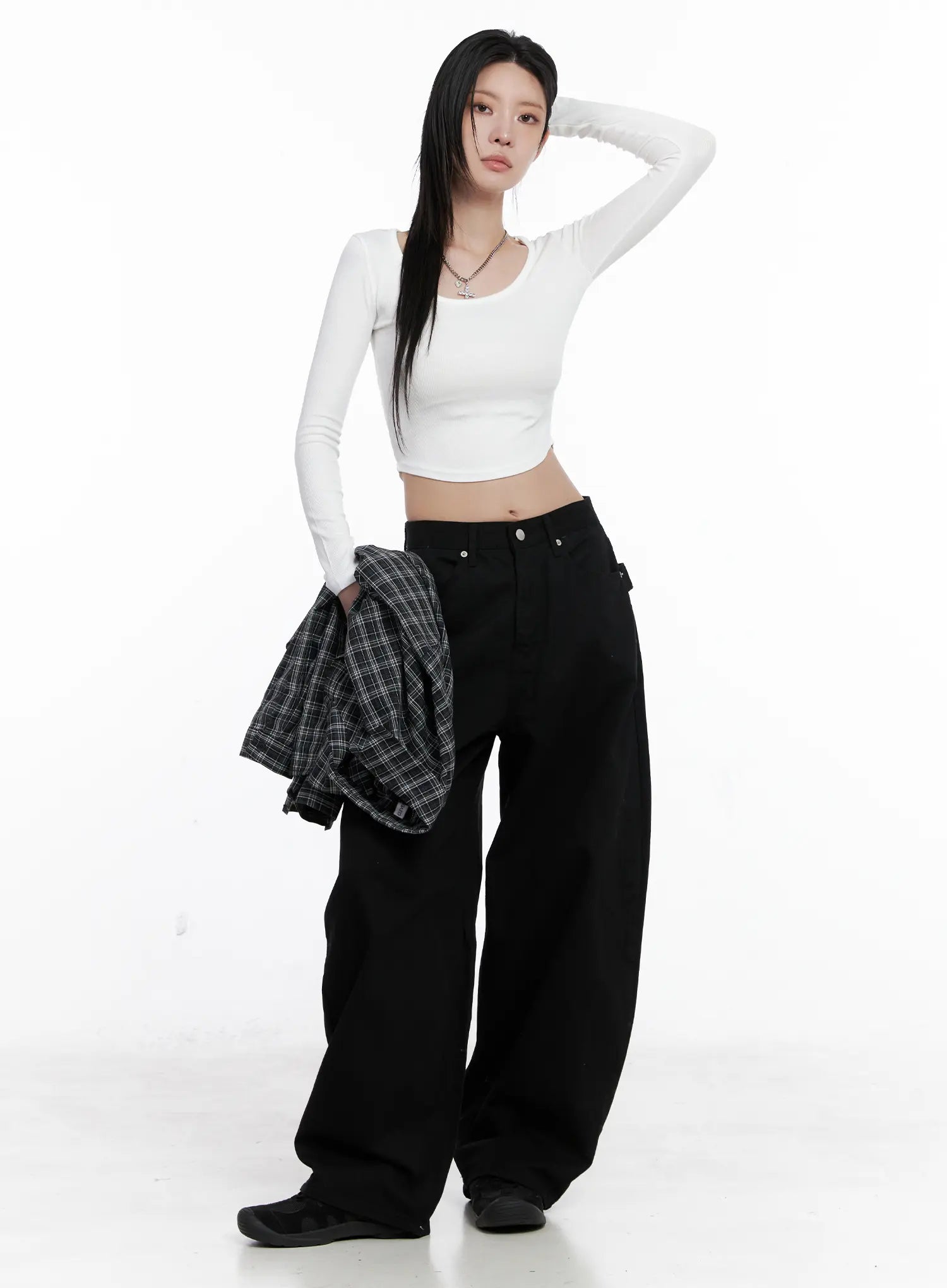 Nana Studded Belt Balloon Jeans CS512 in black, full-body front on model, styled with white crop long-sleeve top and plaid shirt held in hand, oversized balloon leg silhouette.