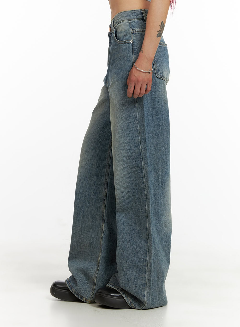 Wide Washed Denim Jeans CY429 in blue, side view crop shot on model, showing wide-leg silhouette, washed denim texture, side seam, back pocket detail, and extra-long inseam pooling at floor.