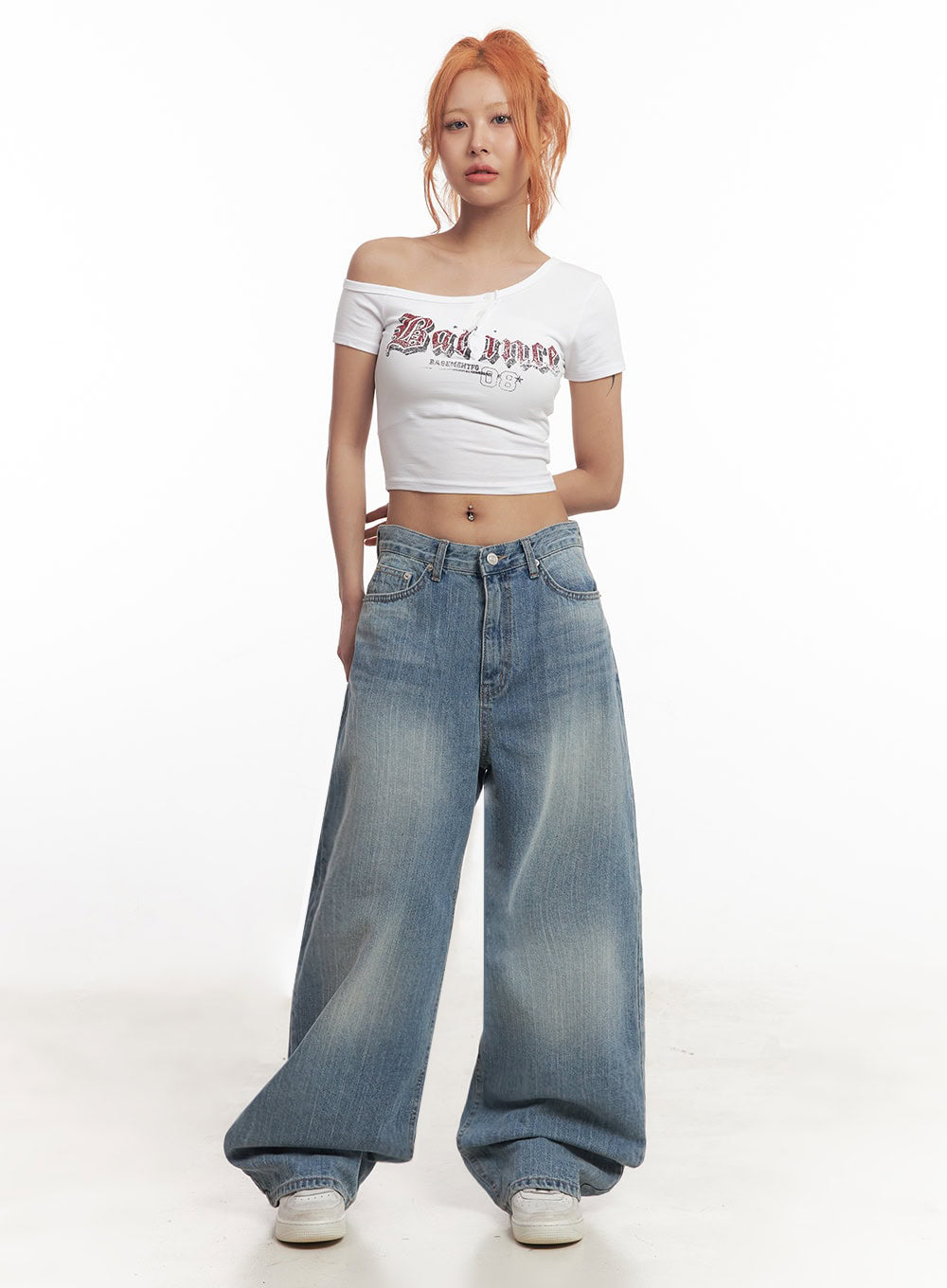 Yvette Washed Baggy Jeans IA517 in light blue, full-length front view on model, ultra-wide baggy leg with sun-faded wash, low rise waistband, styled with white off-shoulder crop top and white sneakers.
