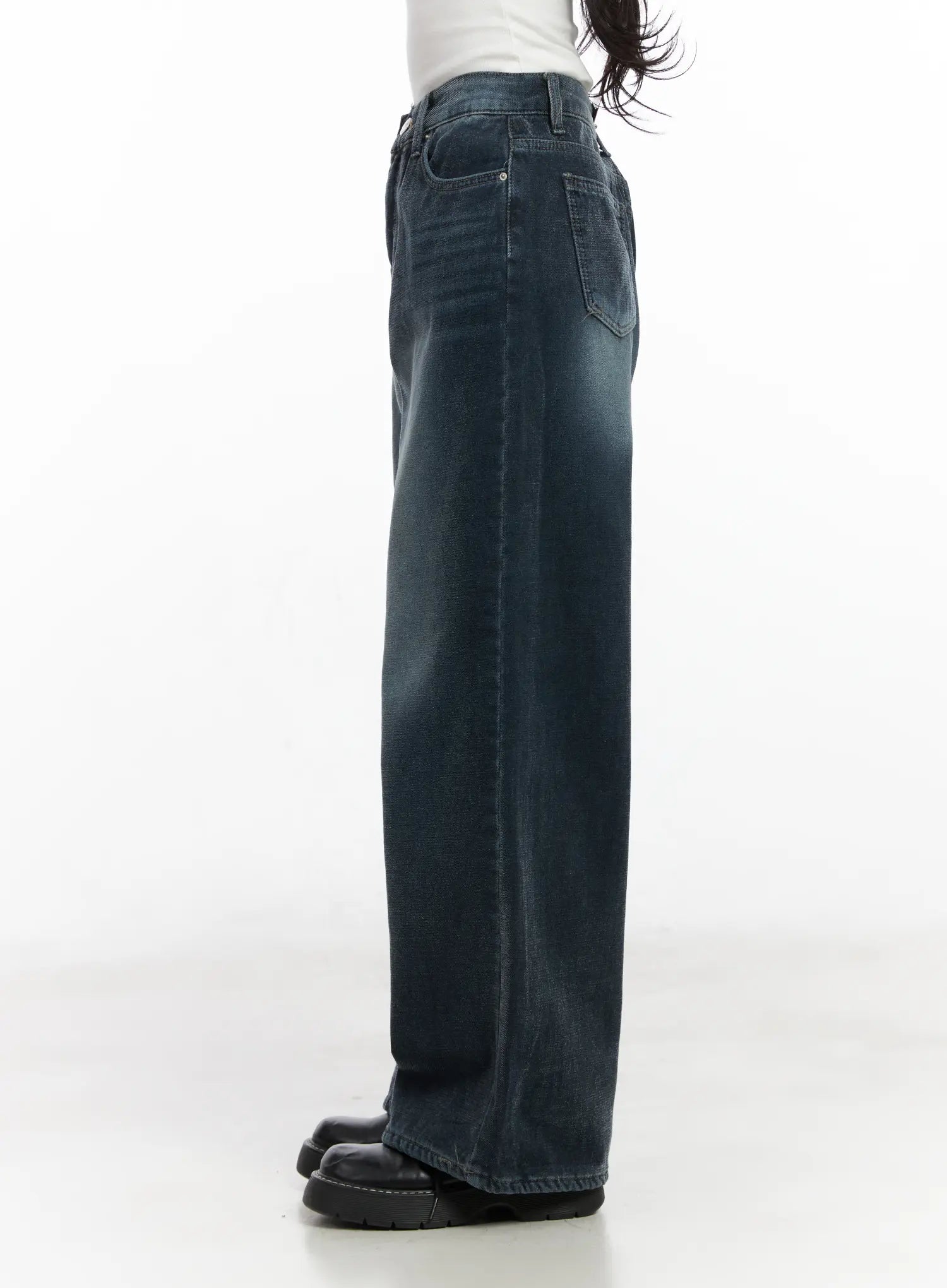 Zariah Baggy Jeans CN526 in dark blue, side view on model, showing extra-wide leg silhouette and long length in washed cotton denim with back pocket visible.