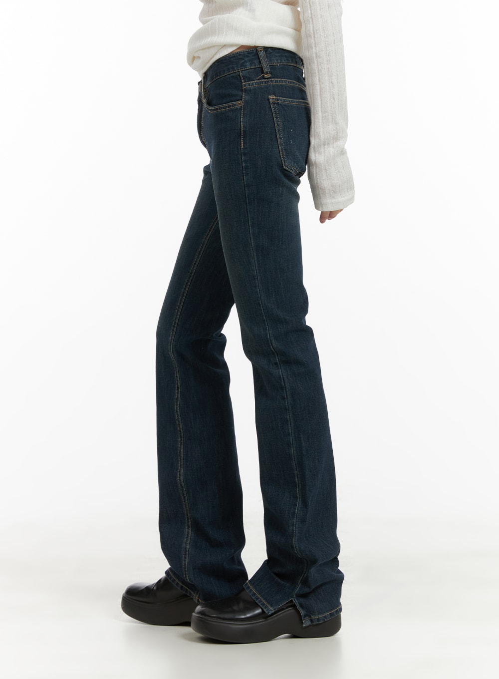 Slim Fit Bootcut Jeans CA418 in dark blue, side view on model, slim leg silhouette flaring at ankle, washed denim with contrast stitching, paired with white knit top.