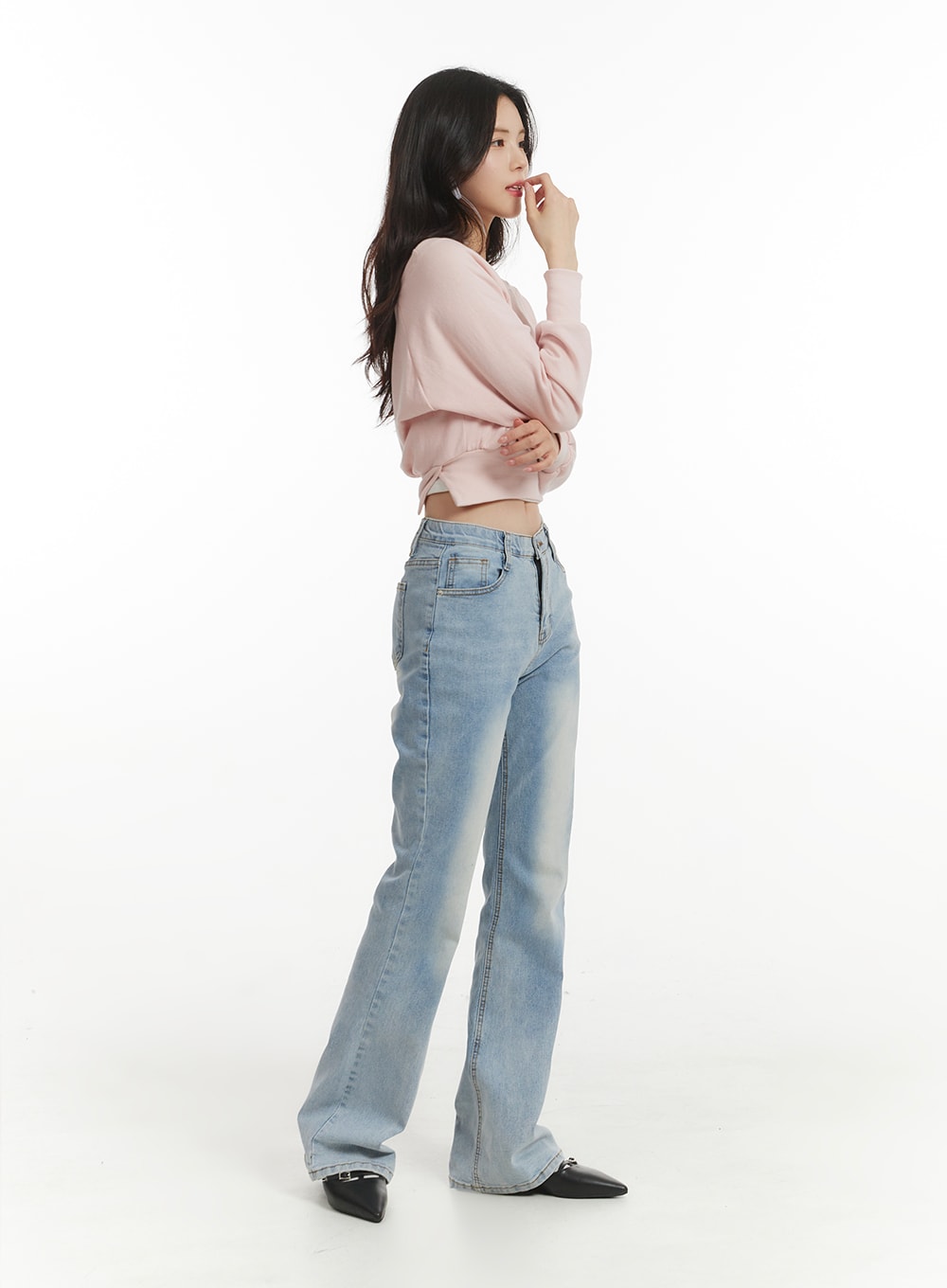 Light Washed Bootcut Jeans OF427 in light blue, side view on model, slim high-rise silhouette with gentle bootcut flare, light wash denim, styled with pink crop top.