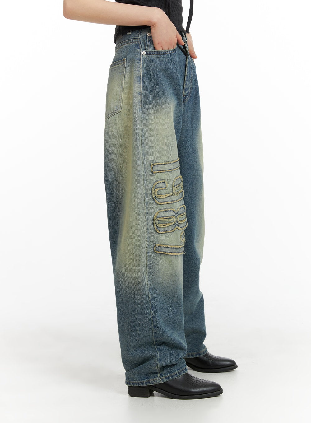 Distressed Baggy Straight Jeans CM413 in blue, side view on model, showing full leg length of wide-fit washed denim with large frayed '1987' appliqué detail and green-yellow fade wash.