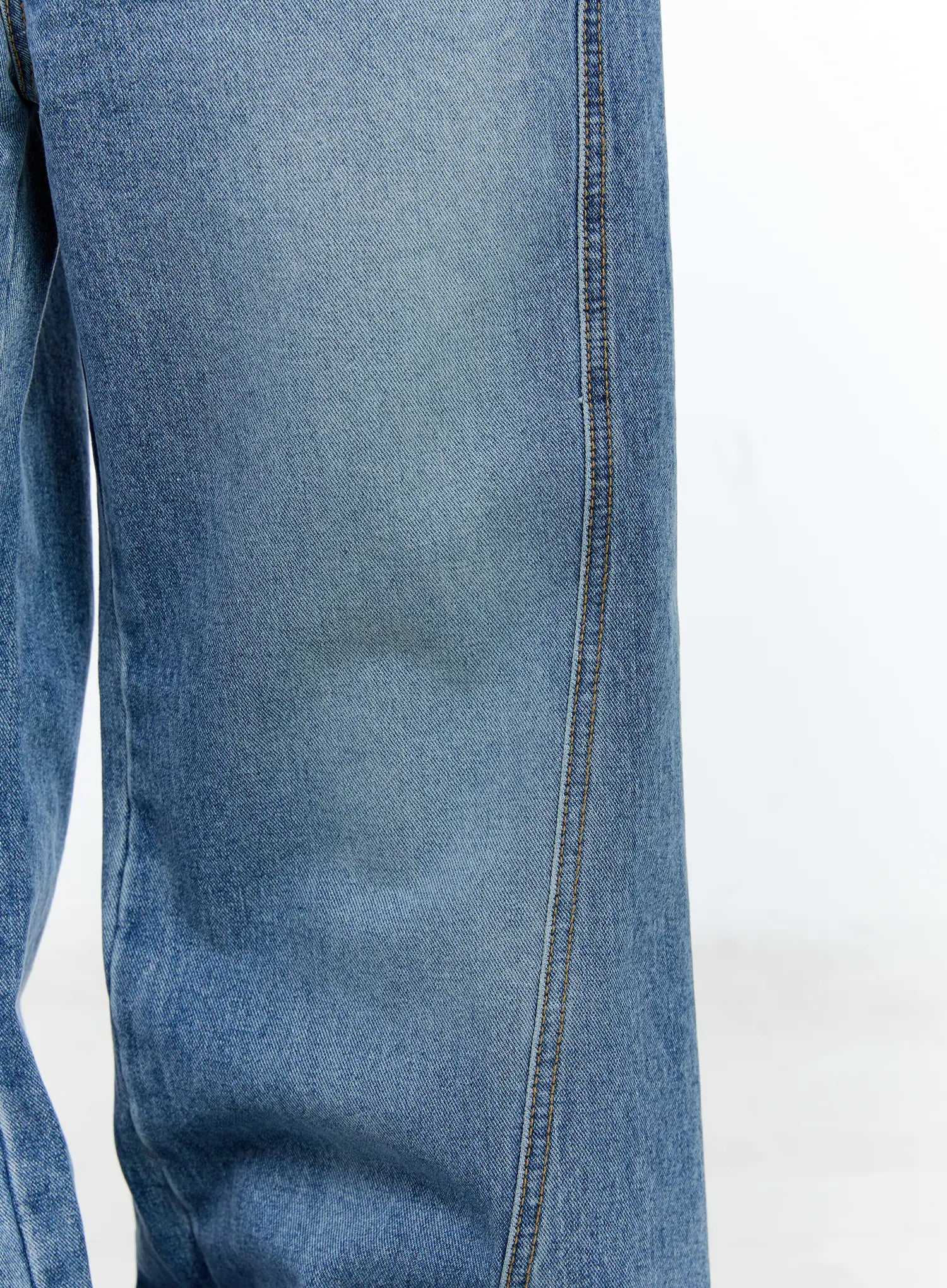 Ana Wide-Leg Denim Jeans CG507 in blue, macro close-up of leg panel, washed cotton denim texture with contrast topstitch center seam visible.