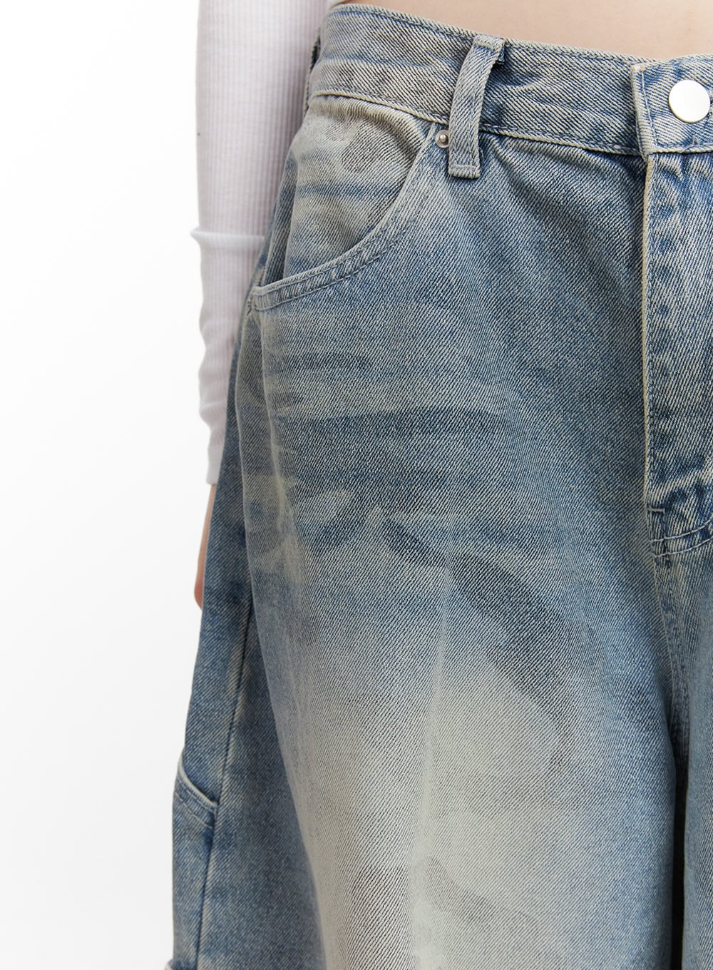 Abigail Camo-Print Carpenter Baggy Jeans CJ528 in blue, close-up of waistband and front pocket area, washed camo-print cotton denim texture and coin pocket detail visible.