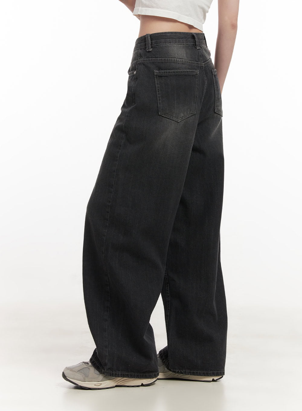 Ruth Washed Wide-Leg Jeans CF514 in black, back three-quarter detail view on model, showing back patch pocket and washed denim texture, paired with white crop top and sneakers.