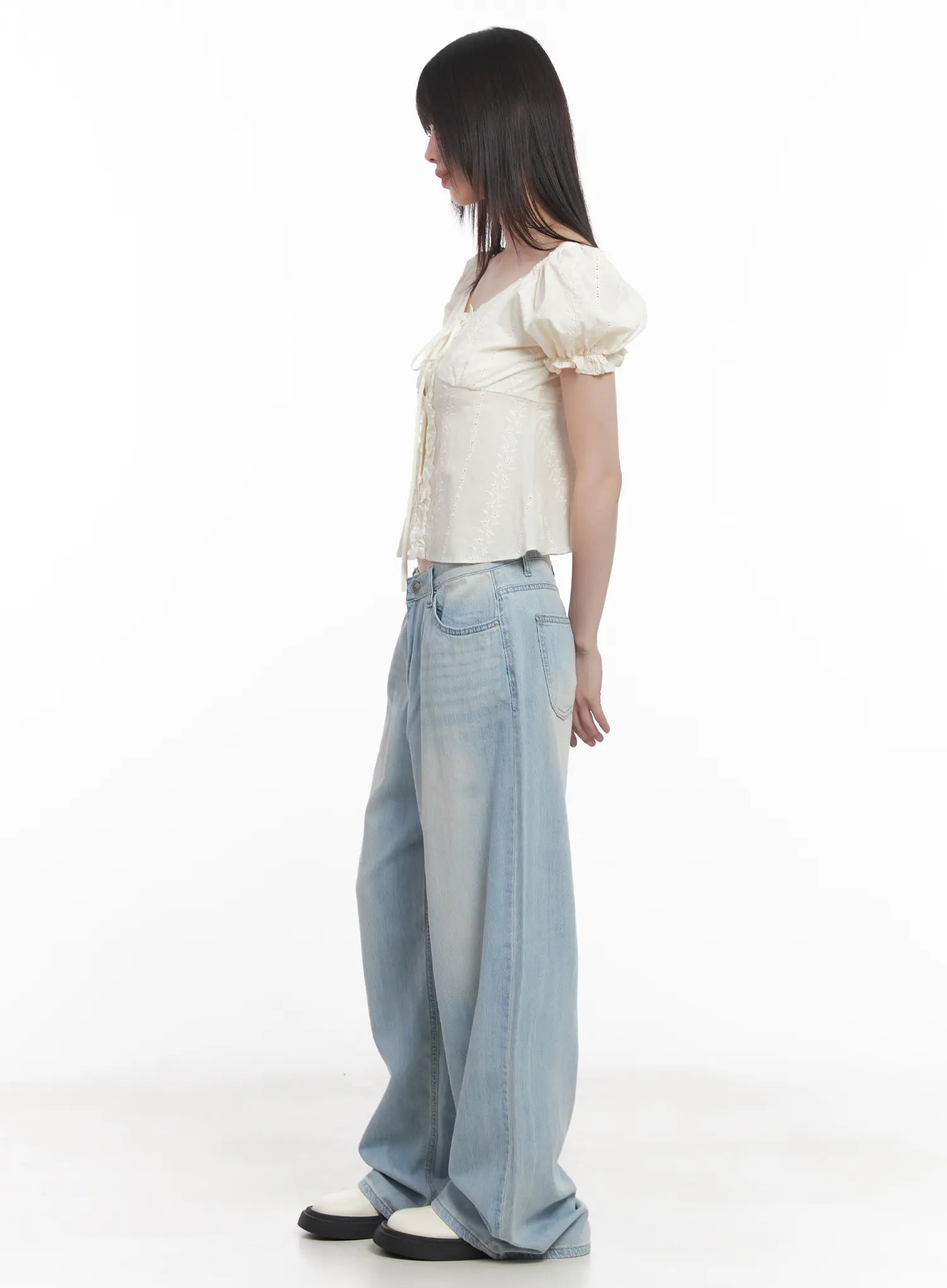 Garam Washed Wide-Leg Jeans CU518 in light blue, side view on model, floor-grazing wide leg with subtle washed fade, styled with cream puff-sleeve top and white shoes.