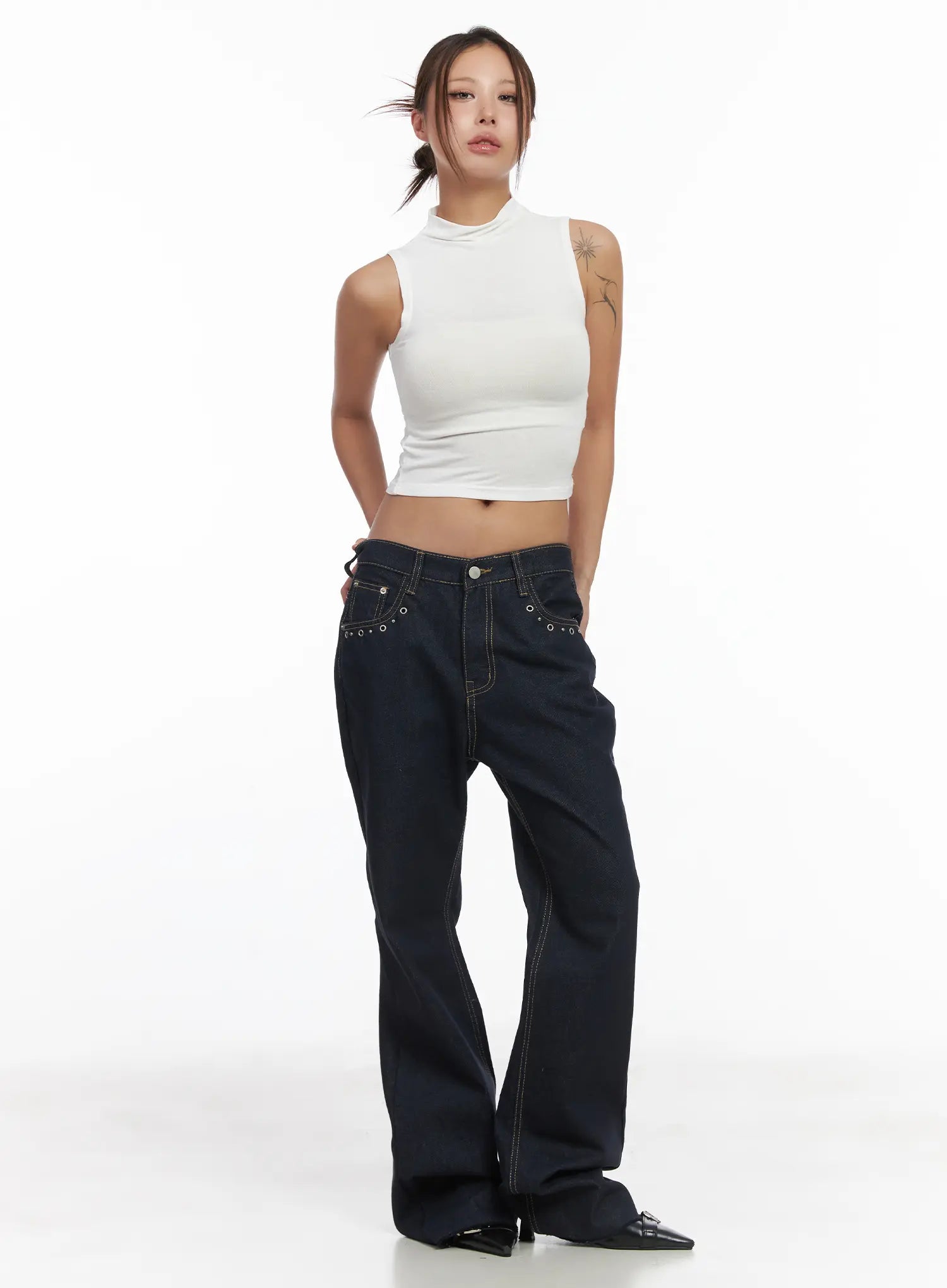 Bunn Non-Fade Eyelet Bootcut Jeans CJ512 in dark blue, front full-length shot on model, wide-fit cotton denim with eyelet pocket trim, paired with white sleeveless mock-neck crop top.