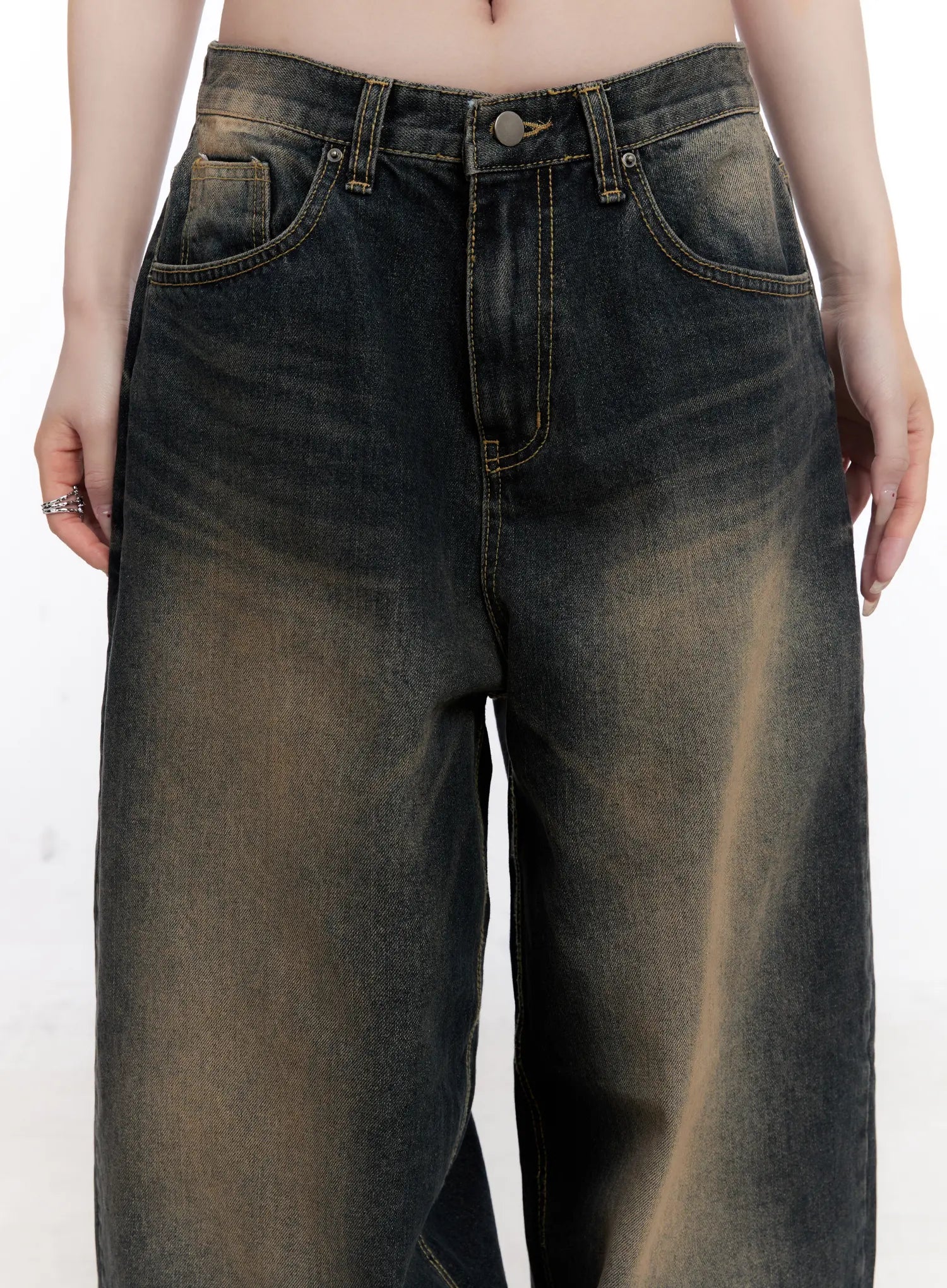Sylvia Vintage Washed Baggy Jeans CO501 in dark blue, waist close-up on model, showing front pockets, button fly, contrast topstitching, and amber vintage wash detail on cotton denim.