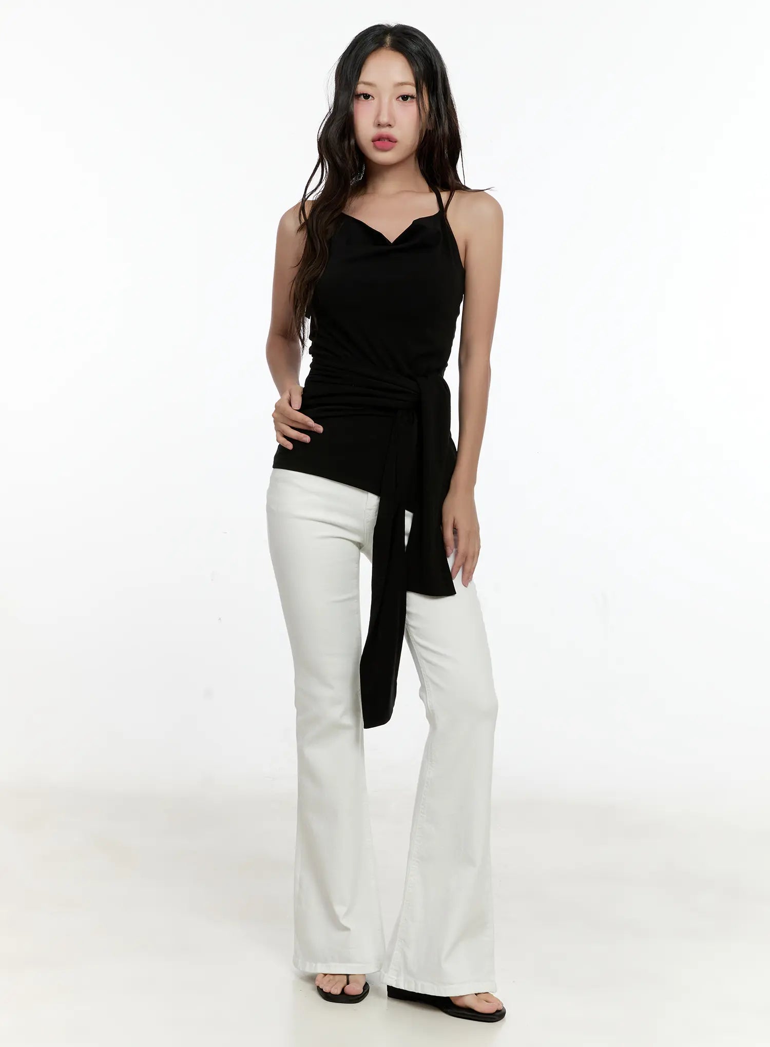 High-Waist Flare Pants CG501 in white, slightly angled front full-body shot on model, slim high-waist fit with bootcut flare, worn with black halter top.