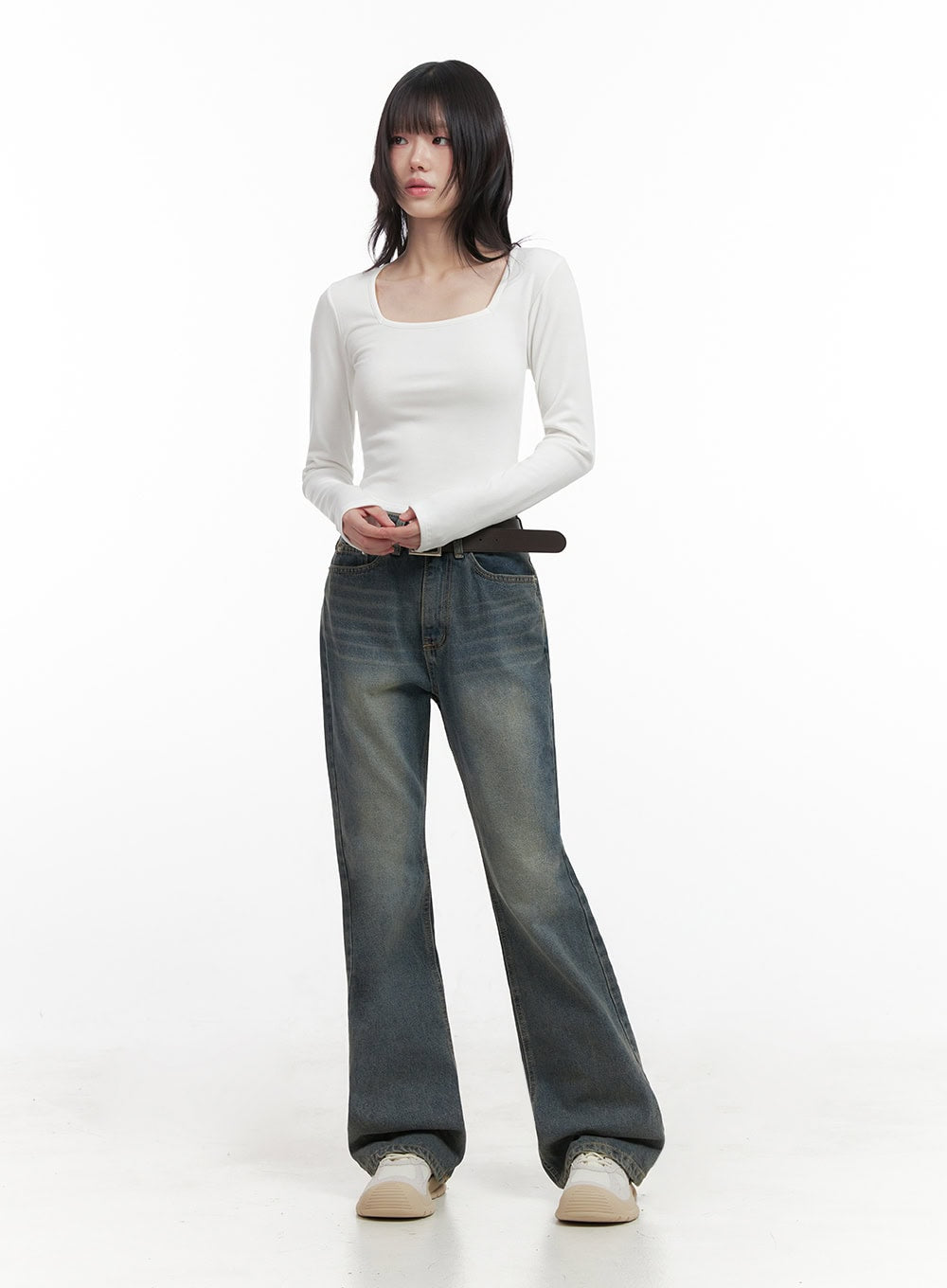 Asher Slimline Washed Bootcut Jeans ID402 in vintage blue, front full-body view on model, slim fit with subtle bootcut flare, faded wash, brown leather belt, white long-sleeve top.