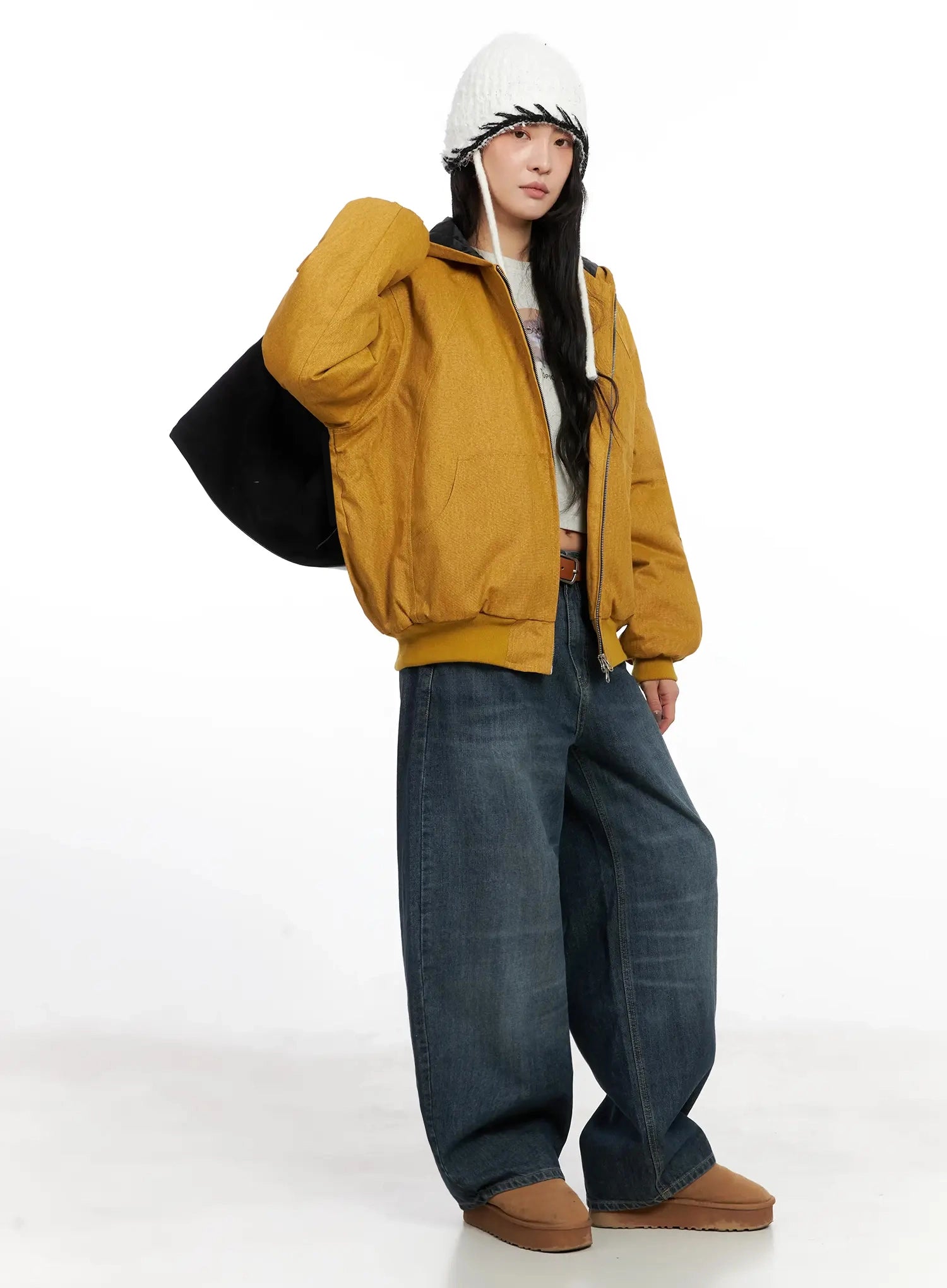 Regina Contrast Stitch Baggy Jeans IN528 in dark blue wash, front three-quarter view on model, wide baggy fit washed cotton denim, paired with mustard zip hoodie, black tote, and white beanie.