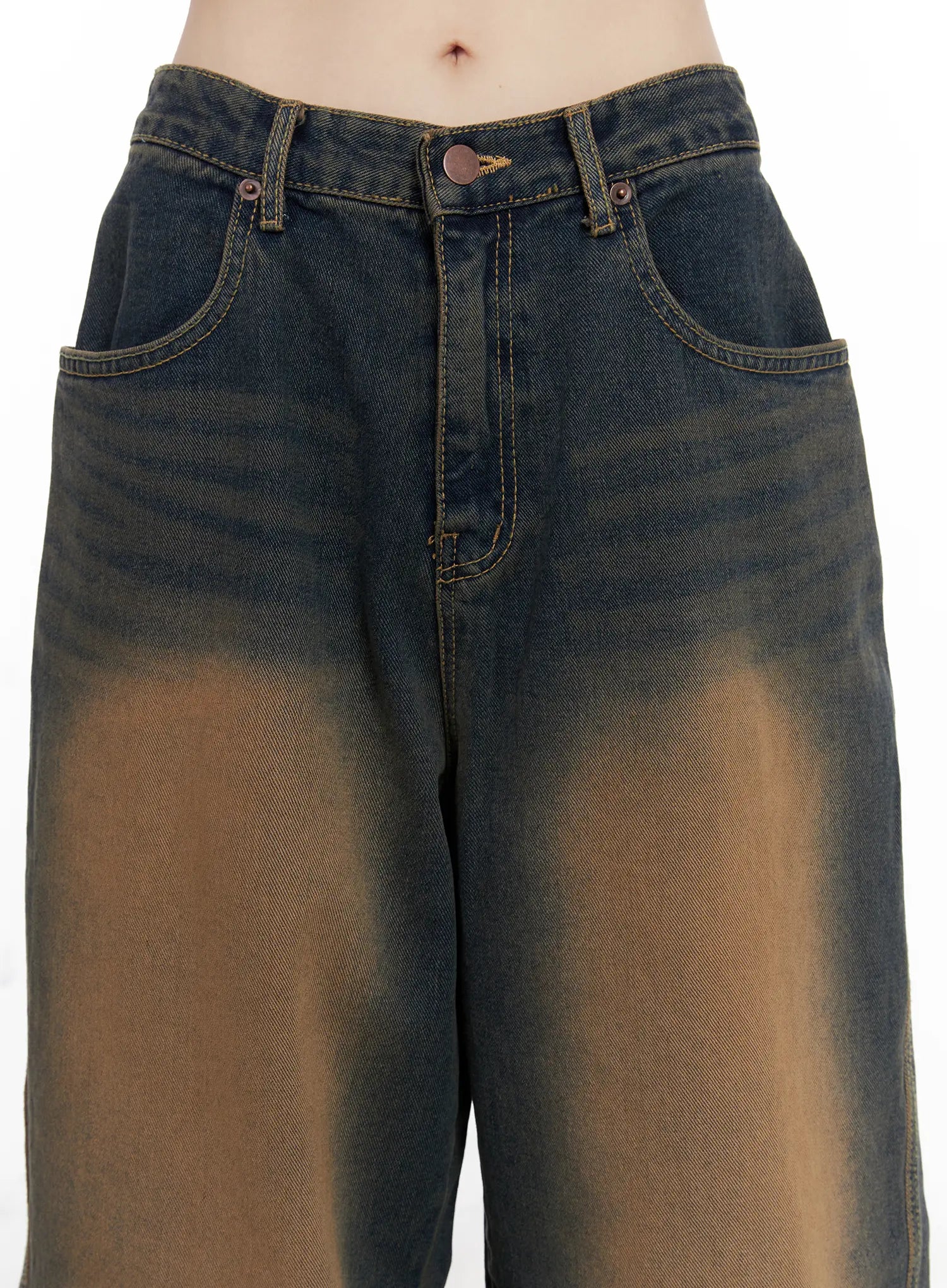 Jaycee Vintage Wash Baggy Jeans CG519 in dark blue, waist close-up on model, showing button fly, front pockets, and brown sun-faded vintage wash detail on cotton denim.