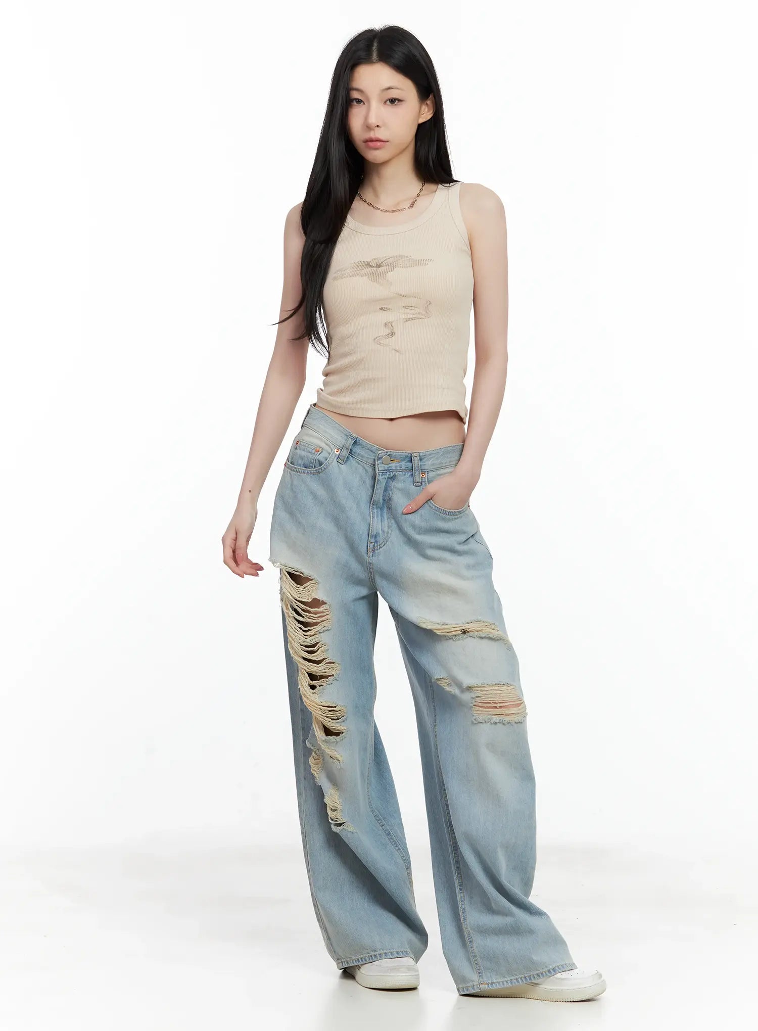 Gyuri Dirty-Wash Distressed Wide Jeans CU530 in blue, full-body front on model, low-rise wide fit with heavy rips, styled with beige ribbed crop tank and white sneakers.