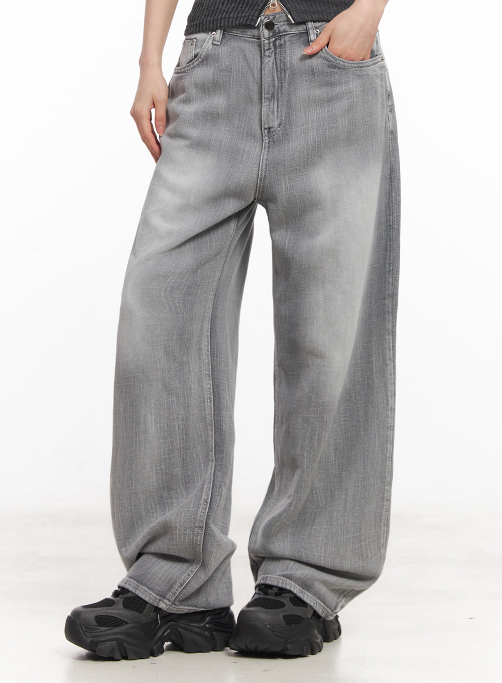 Flore Washed Wide-Leg Jeans IY516 in gray, front side close-up on model, washed denim texture with roomy wide leg and subtle fading, hand in pocket.