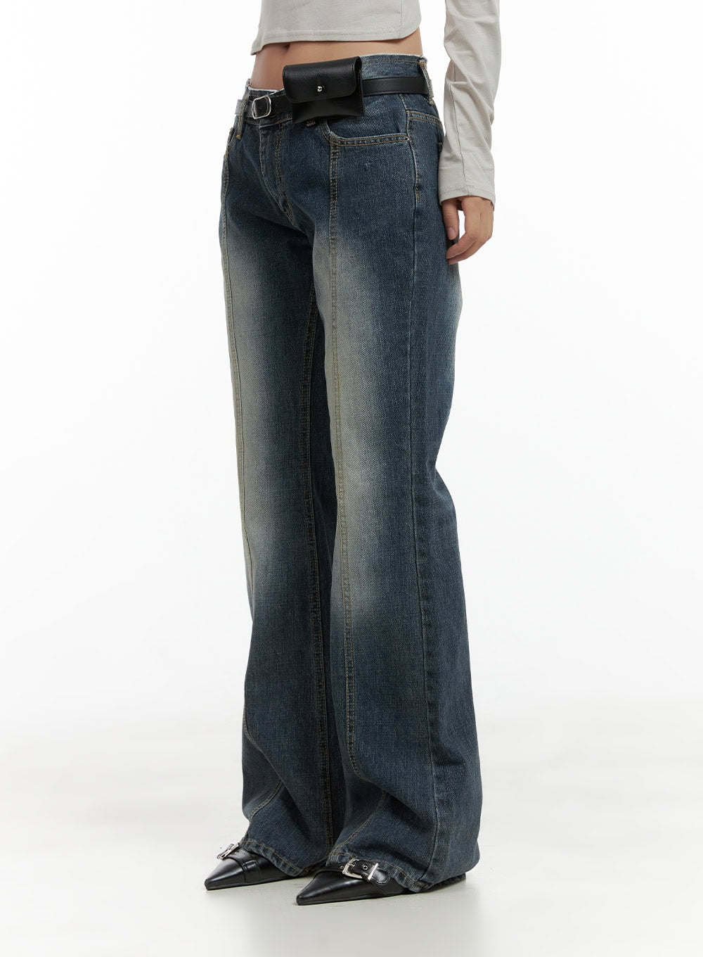 Low Rise Front Seam Bootcut Jeans CL417 in dark blue, side view on model, front seam stitching and subtle bootcut flare visible, styled with black leather belt bag and pointed shoes.