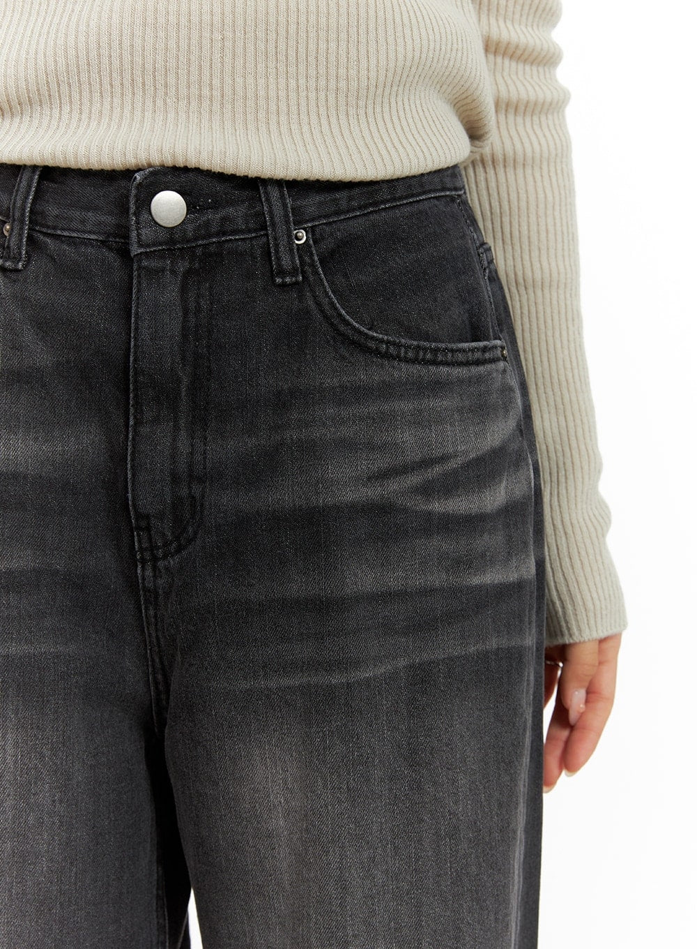 Pintuck Washed Wide Leg Jeans CA403 in Black, waist close-up on model, high-rise fit with silver button, coin pocket, and faded washed cotton denim texture, tucked with cream ribbed knit.